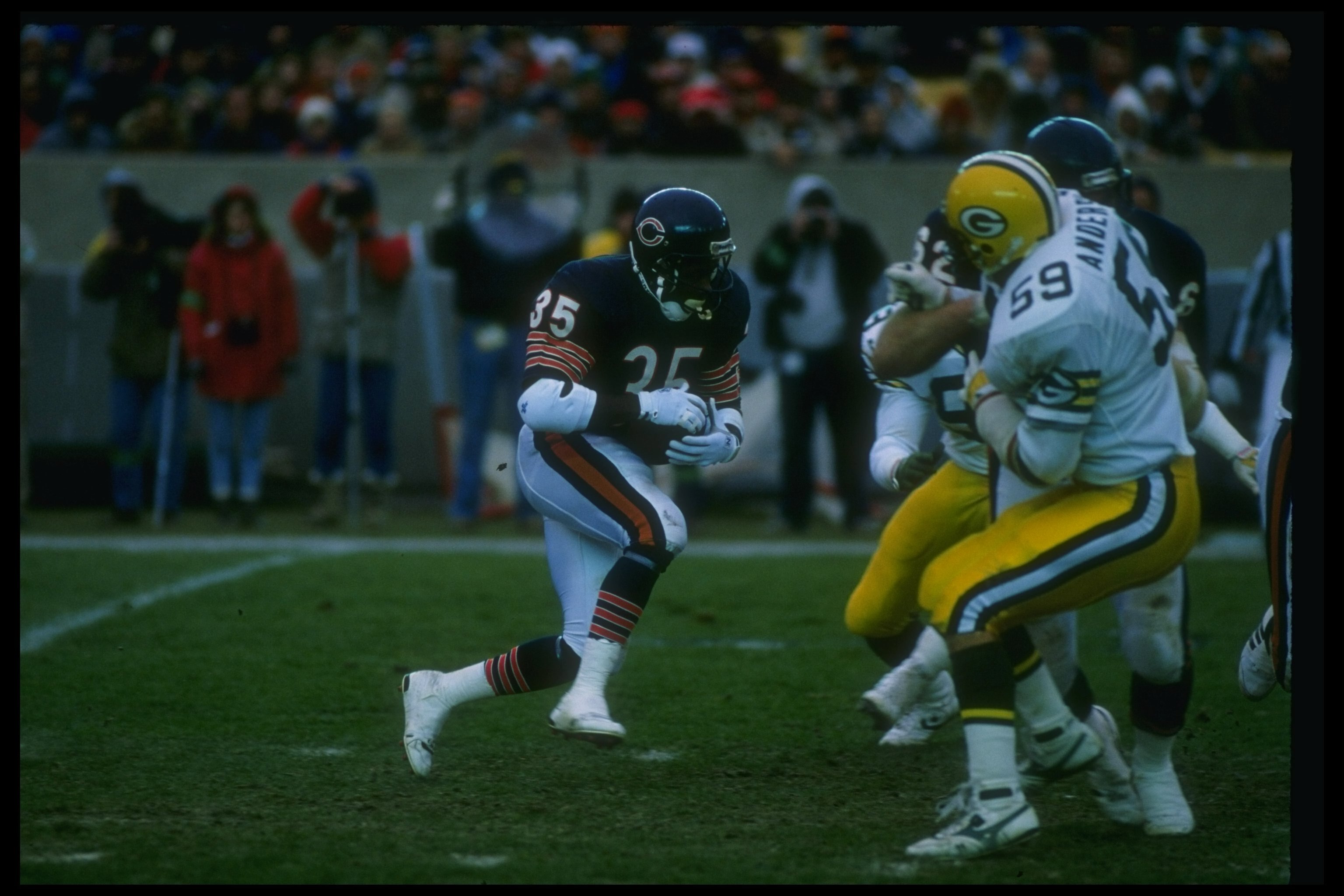 27 Nov 1988: Running back Neal Anderson of the Chicago Bears (left) runs with the ball during a game against the Green Bay Packers at Soldier Field in Chicago, Illinois. The Bears won the game, 16-0.
