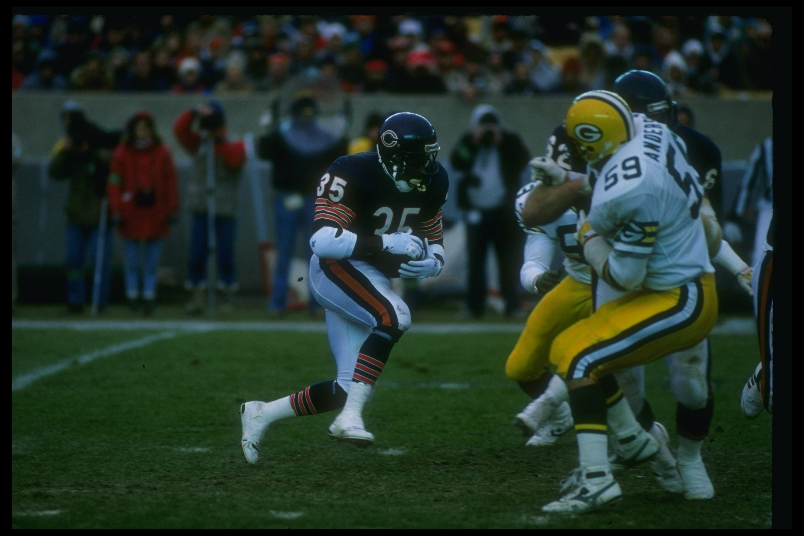 27 Nov 1988: Running back Neal Anderson of the Chicago Bears (left) runs with the ball during a game against the Green Bay Packers at Soldier Field in Chicago, Illinois. The Bears won the game, 16-0.