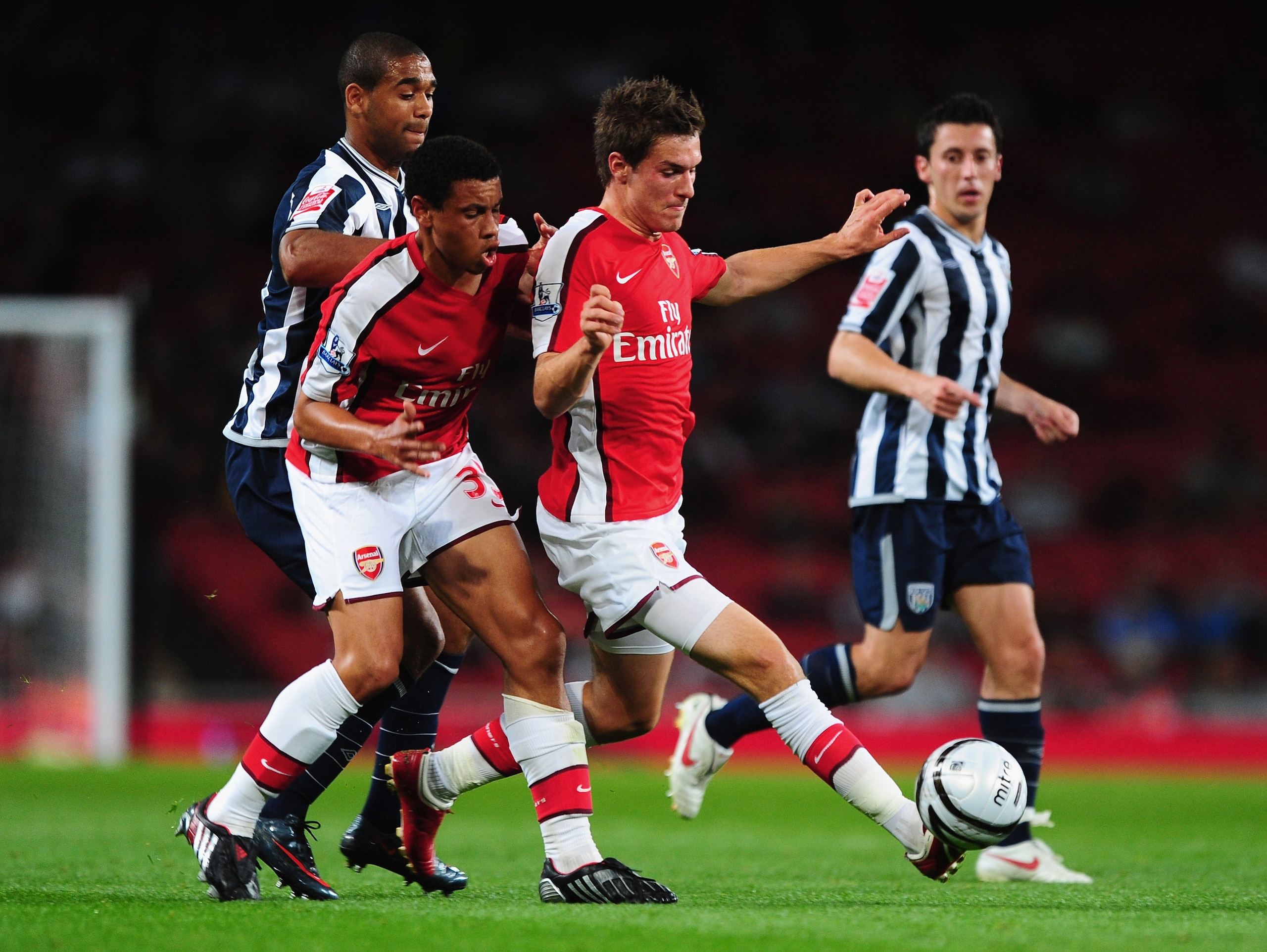 LONDON, ENGLAND - SEPTEMBER 22:  Francis Coquelin and Aaron Ramsey of Arsenal shield the ball from Luke Moore of West Bromwich Albion during the Carling Cup match between Arsenal and West Bromwich Albion at Emirates Stadium on September 22, 2009 in London