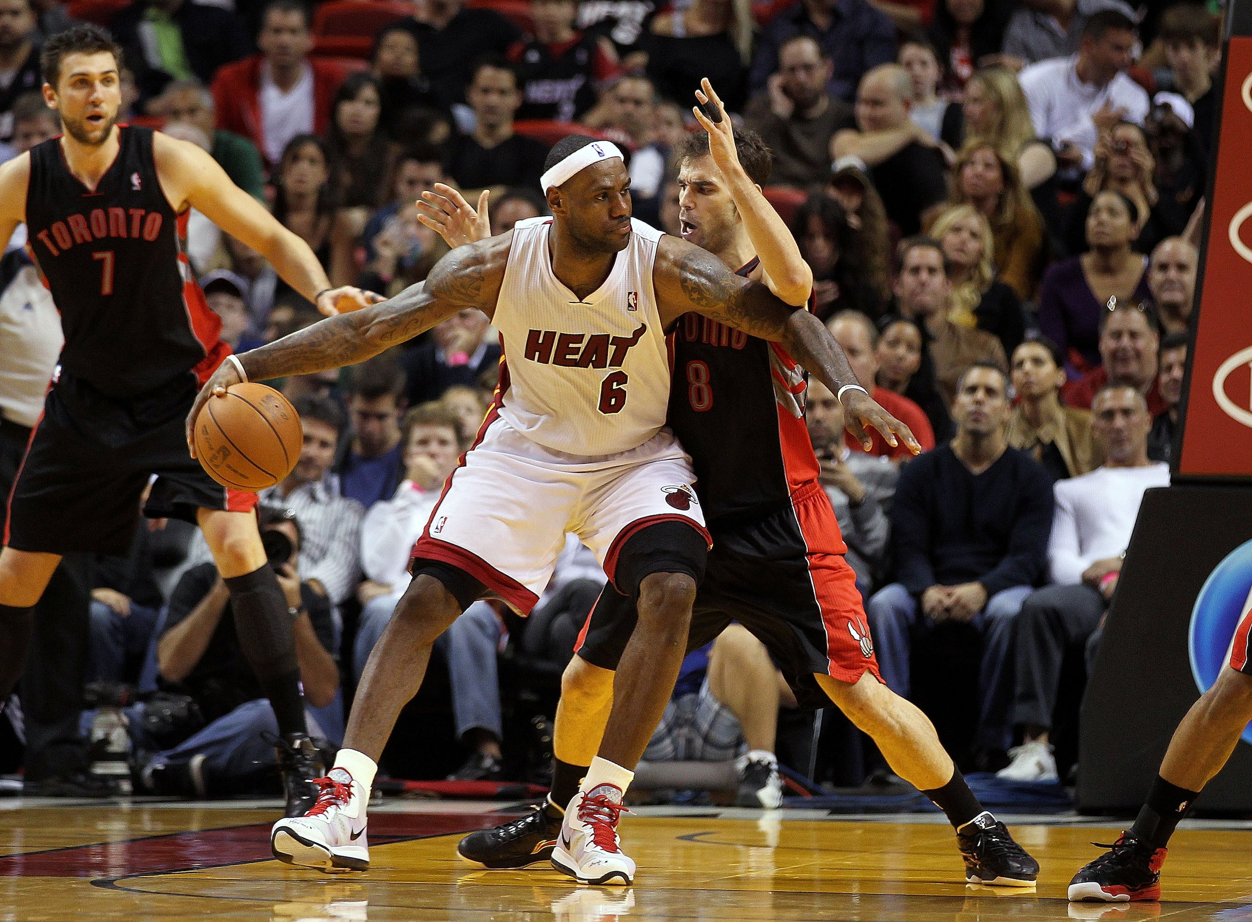 MIAMI, FL - JANUARY 22:  LeBron James #6 of the Miami Heat posts up Jose Calderon #8 of the Toronto Raptors during a game  at American Airlines Arena on January 22, 2011 in Miami, Florida. NOTE TO USER: User expressly acknowledges and agrees that, by down