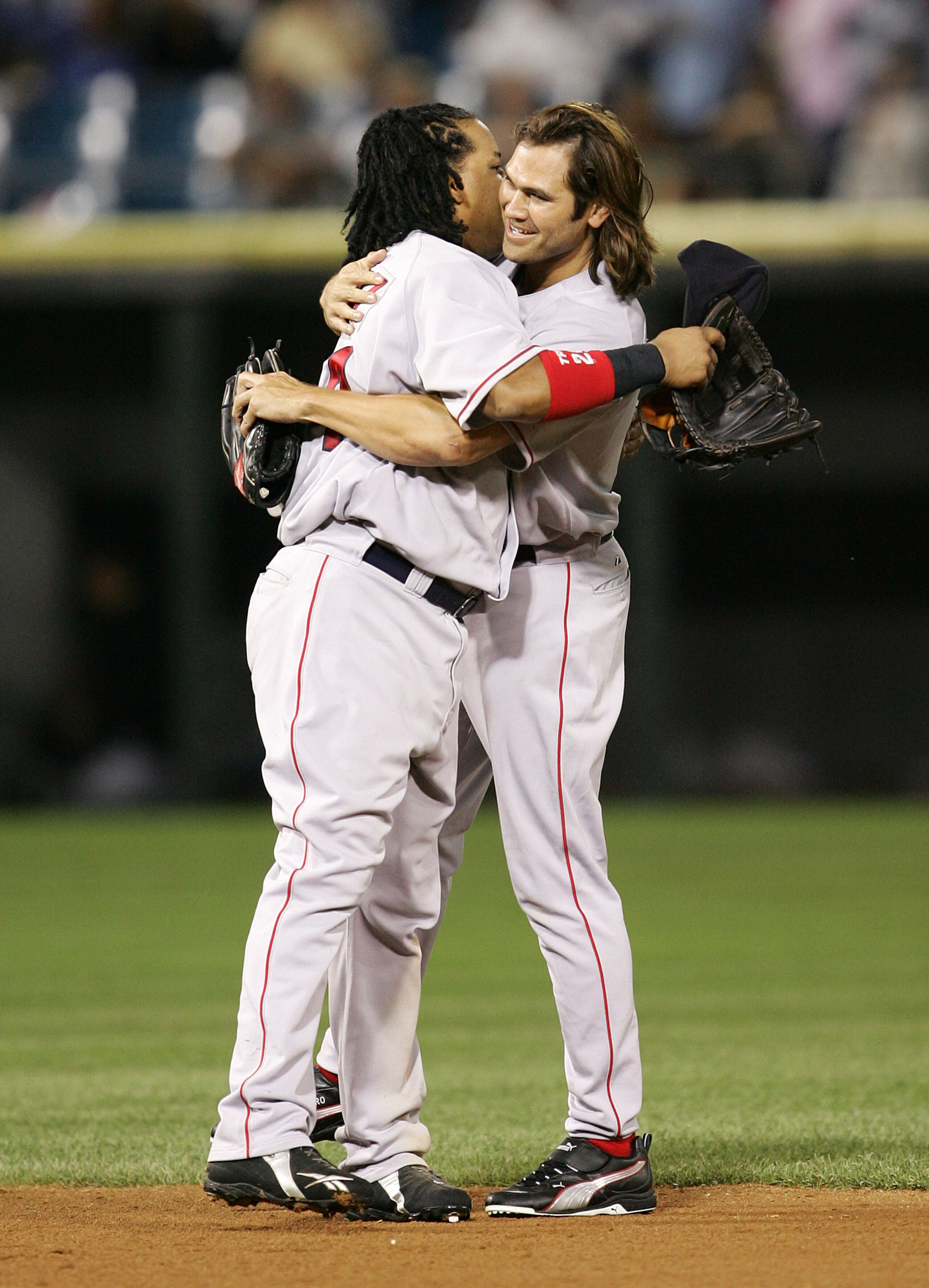 CHICAGO - JULY 21: Johnny Damon #18 of the Boston Red Sox hugs teammate Manny Ramirez #24 after a win against the Chicago White Sox July 21, 2005 at U.S. Cellular Field in Chicago, Illinois. The Red Sox defeated the White Sox 6-5. (Photo by Jonathan Dan CHICAGO - JULY 21: Johnny Damon #18 of the Boston Red Sox hugs teammate Manny Ramirez #24 after a win against the Chicago White Sox July 21, 2005 at U.S. Cellular Field in Chicago, Illinois. The Red Sox defeated the White Sox 6-5. (Photo by Jonathan Dan