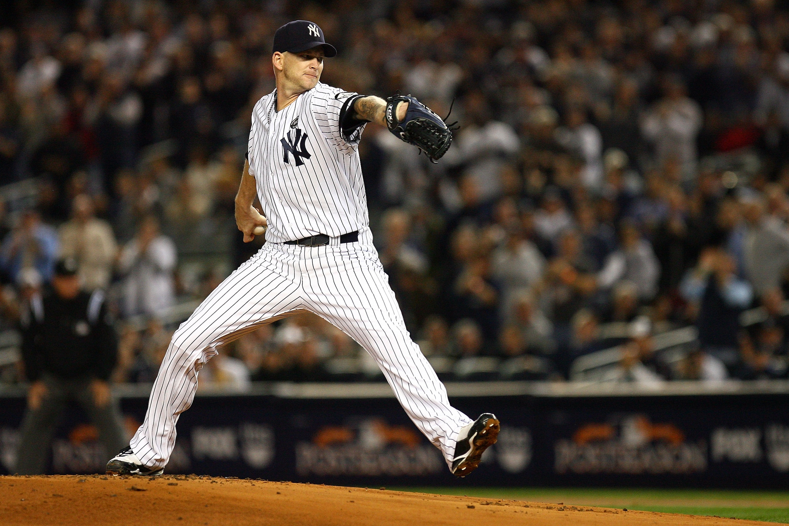 NEW YORK - OCTOBER 19: A.J. Burnett #34 of the New York Yankees pitches against the Texas Rangers in Game Four of the ALCS during the 2010 MLB Playoffs at Yankee Stadium on October 19, 2010 in the Bronx borough of New York City. The Rangers won 10-3. (P NEW YORK - OCTOBER 19: A.J. Burnett #34 of the New York Yankees pitches against the Texas Rangers in Game Four of the ALCS during the 2010 MLB Playoffs at Yankee Stadium on October 19, 2010 in the Bronx borough of New York City. The Rangers won 10-3. (P
