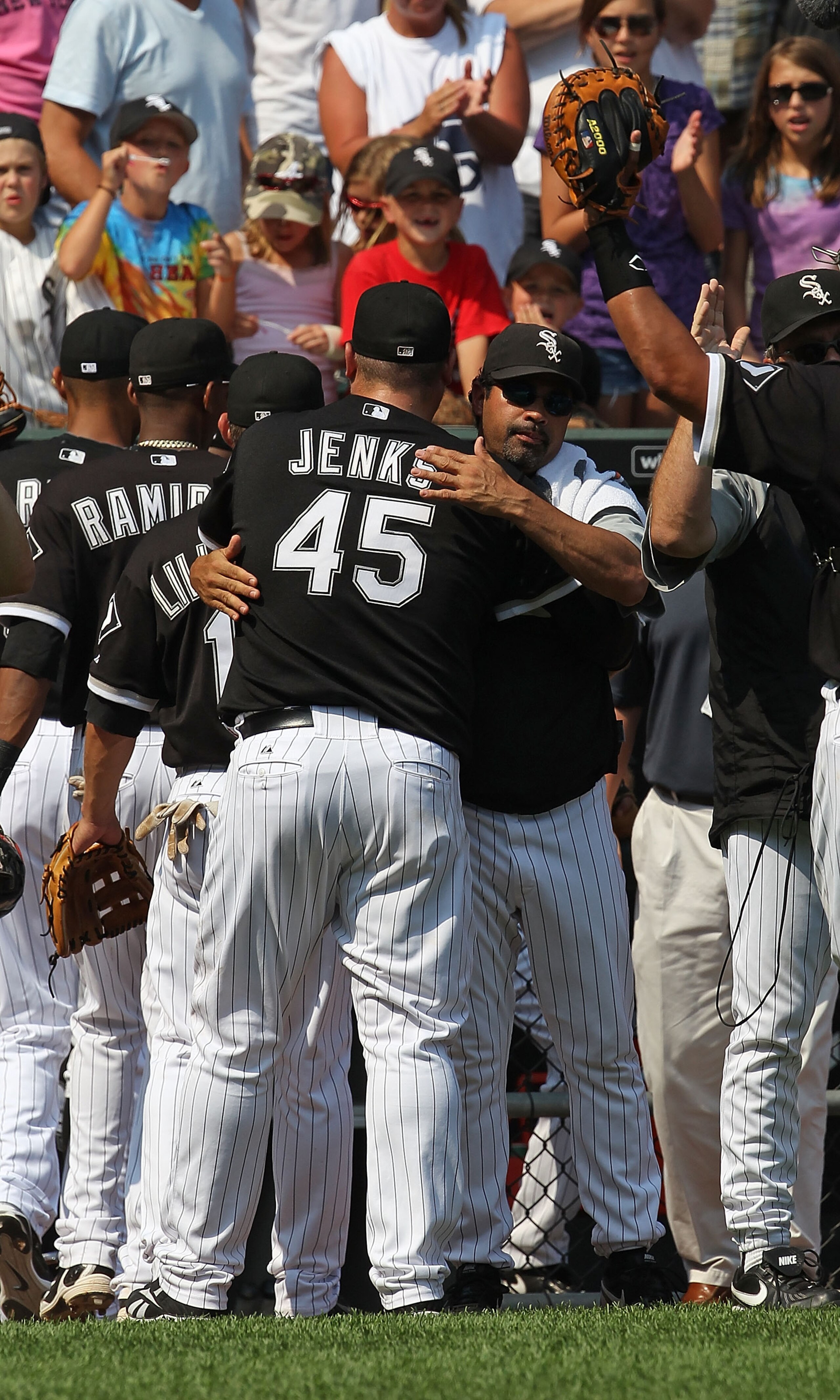 CHICAGO - AUGUST 01: Manager Ozzie Guillen #13 of the Chicago White Sox hugs closing pitcher Bobby Jenks #45 after a win over the Oakland Athletics at U.S. Cellular Field on August 1, 2010 in Chicago, Illinois. The White Sox defeated the Athletics 4-1. (P CHICAGO - AUGUST 01: Manager Ozzie Guillen #13 of the Chicago White Sox hugs closing pitcher Bobby Jenks #45 after a win over the Oakland Athletics at U.S. Cellular Field on August 1, 2010 in Chicago, Illinois. The White Sox defeated the Athletics 4-1. (P