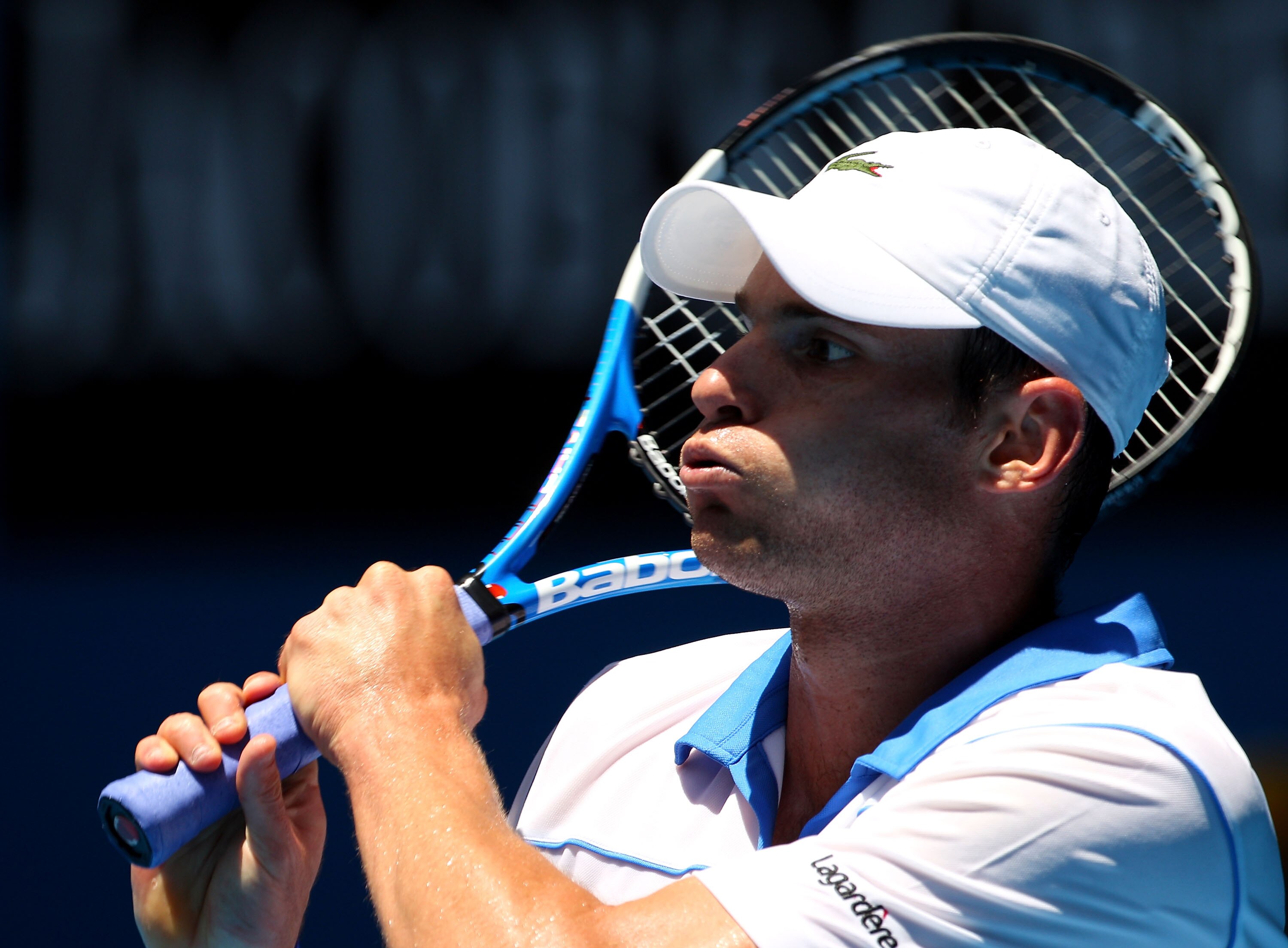 MELBOURNE, AUSTRALIA - JANUARY 21:  Andy Roddick of the United States of America plays a backhand in his third round match against Robin Haase of the Netherlands during day five of the 2011 Australian Open at Melbourne Park on January 21, 2011 in Melbourn