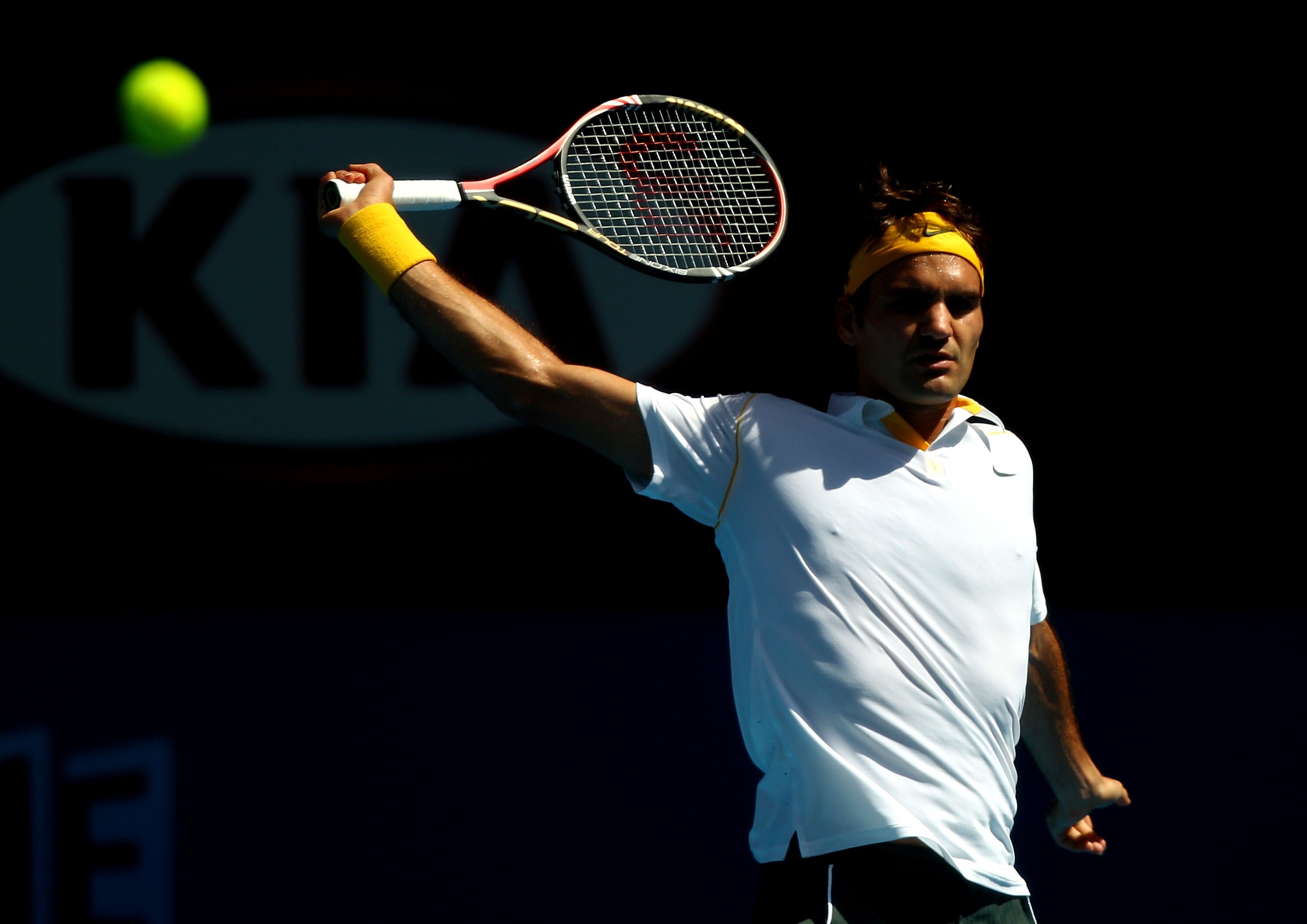 MELBOURNE, AUSTRALIA - JANUARY 21:  Roger Federer of Switzerland plays a backhand in his third round match against Xavier Malisse of Belgium during day five of the 2011 Australian Open at Melbourne Park on January 21, 2011 in Melbourne, Australia.  (Photo