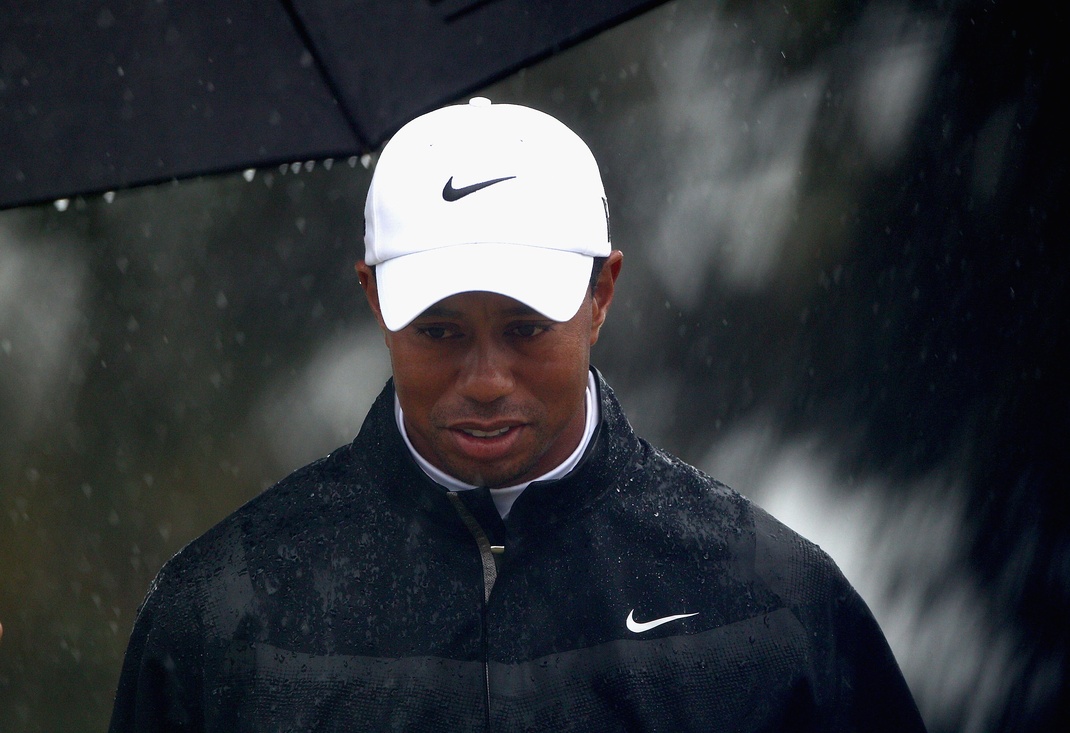 MELBOURNE, AUSTRALIA - NOVEMBER 13:  Tiger Woods of the USA looks on as the rain falls during round three of the Australian Masters at The Victoria Golf Club on November 13, 2010 in Melbourne, Australia.  (Photo by Ryan Pierse/Getty Images)