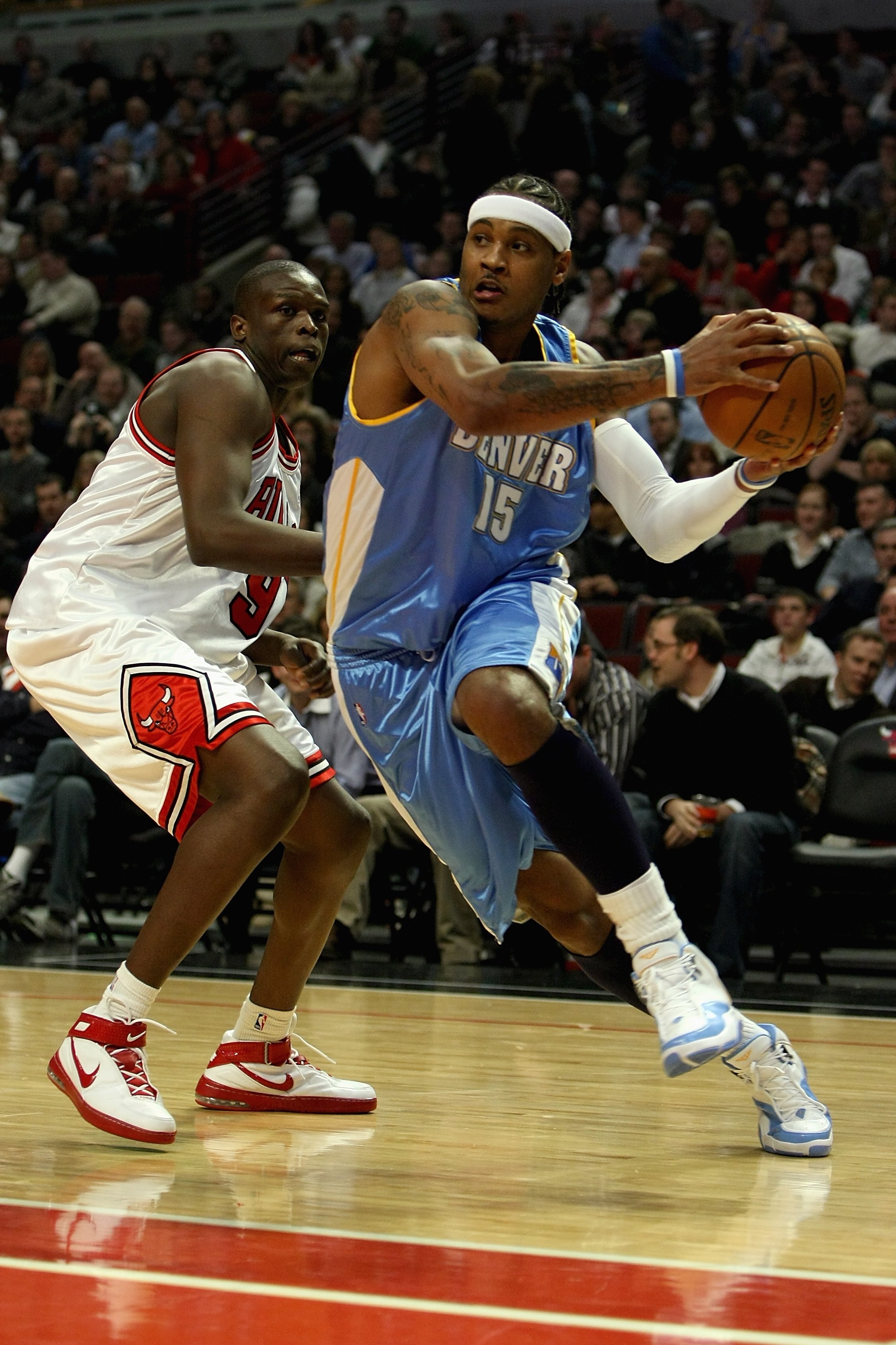 CHICAGO - FEBRUARY 22:  Carmelo Anthony #15 of the Denver Nuggets drives to the basket past Luol Deng #9 of the Chicago Bulls during the game on February 22, 2008 at the United Center in Chicago, Illinois. The Bulls won 135-121. NOTE TO USER: User express