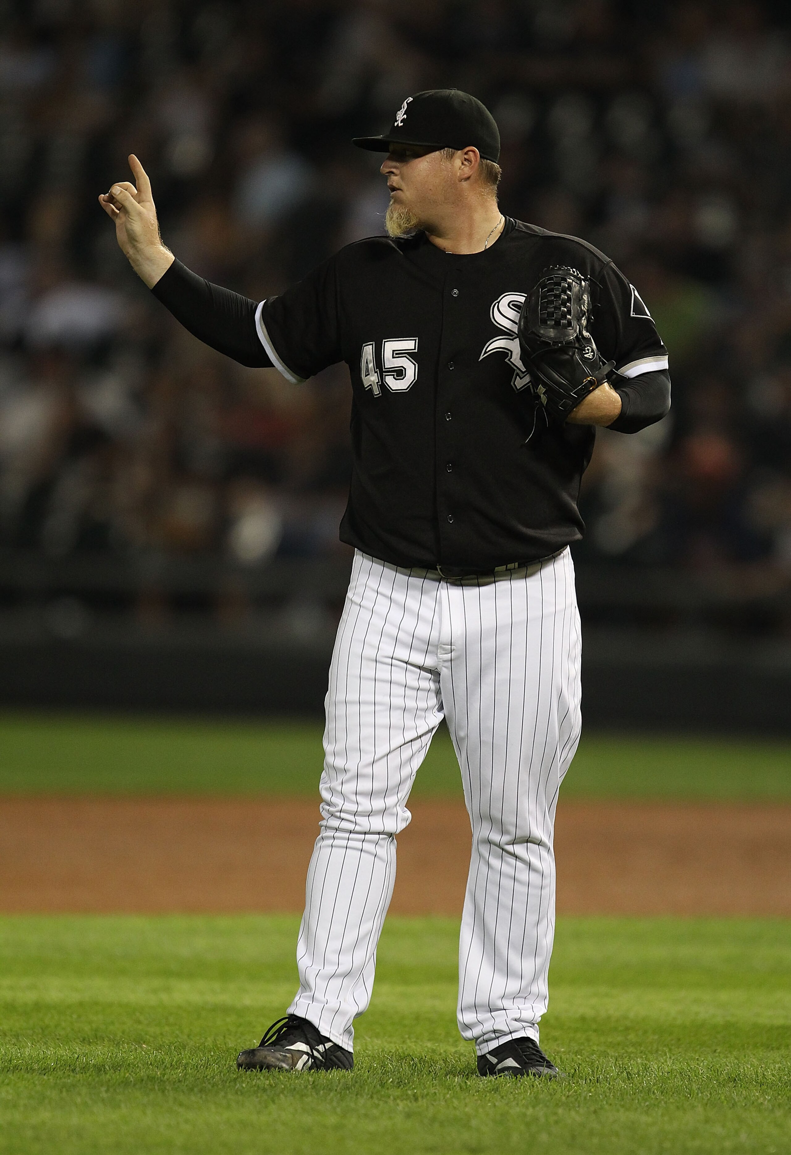 CHICAGO - AUGUST 10: Bobby Jenks #45 of the Chicago White Sox signals to teammates against the Minnesota Twins at U.S. Cellular Field on August 10, 2010 in Chicago, Illinois. The Twins defeated the White Sox 12-6. (Photo by Jonathan Daniel/Getty Images)