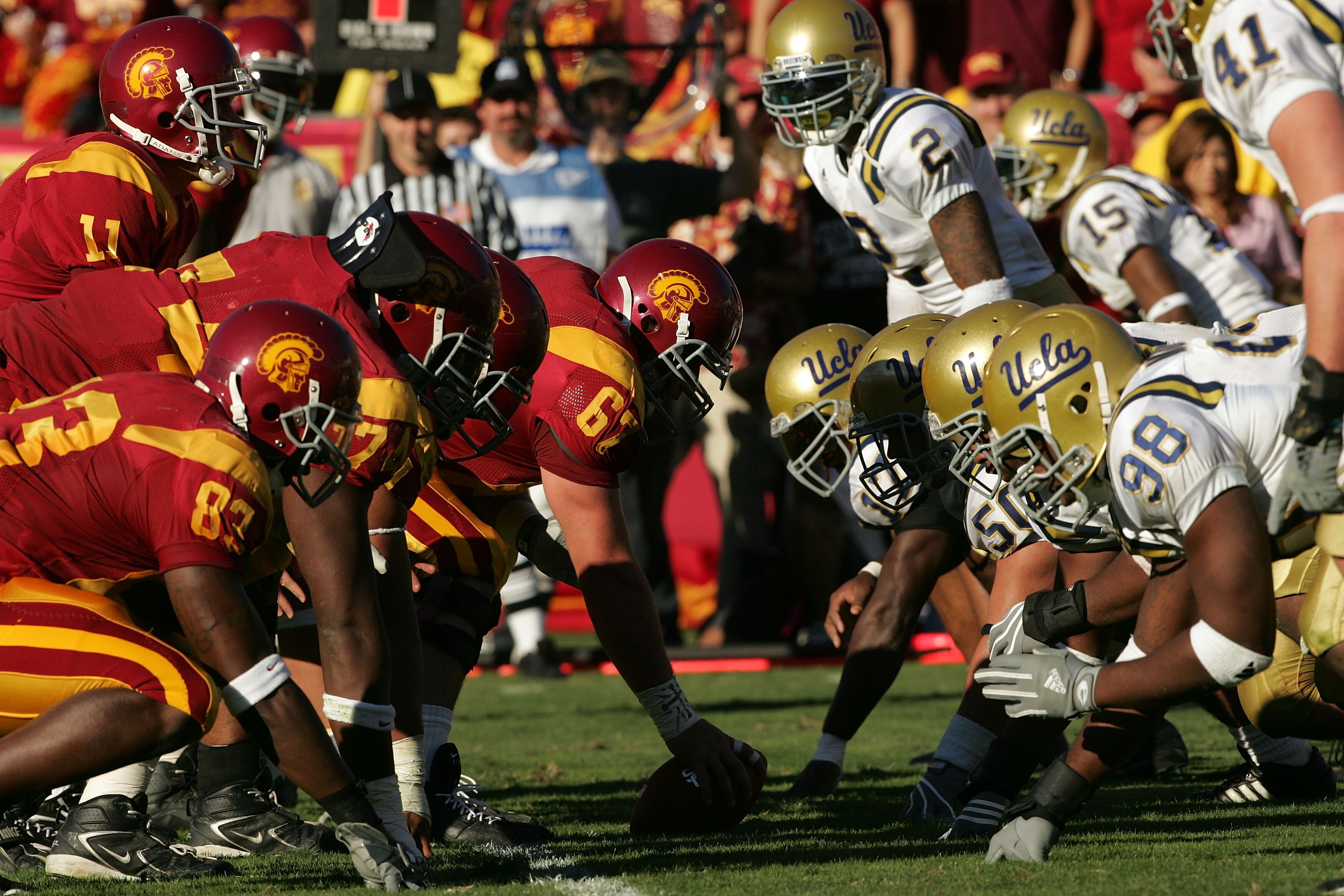 LOS ANGELES, CA - DECEMBER 03:  Matt Leinart (L) #11 of the USC Trojans stands under center Ryan Kalil #67 at the line of scrimmage against the UCLA Bruins defense  December 3, 2005 at the Los Angeles Memorial Coliseum in Los Angeles, California. USC won