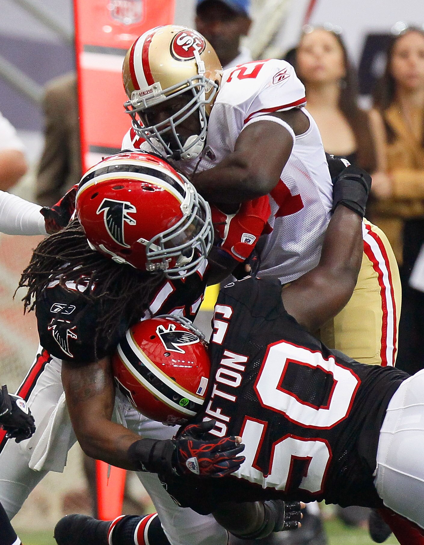 ATLANTA - OCTOBER 03:  Mike Peterson #53 and Curtis Lofton #50 of the Atlanta Falcons tackles Frank Gore #21 of the San Francisco 49ers at Georgia Dome on October 3, 2010 in Atlanta, Georgia.  (Photo by Kevin C. Cox/Getty Images)