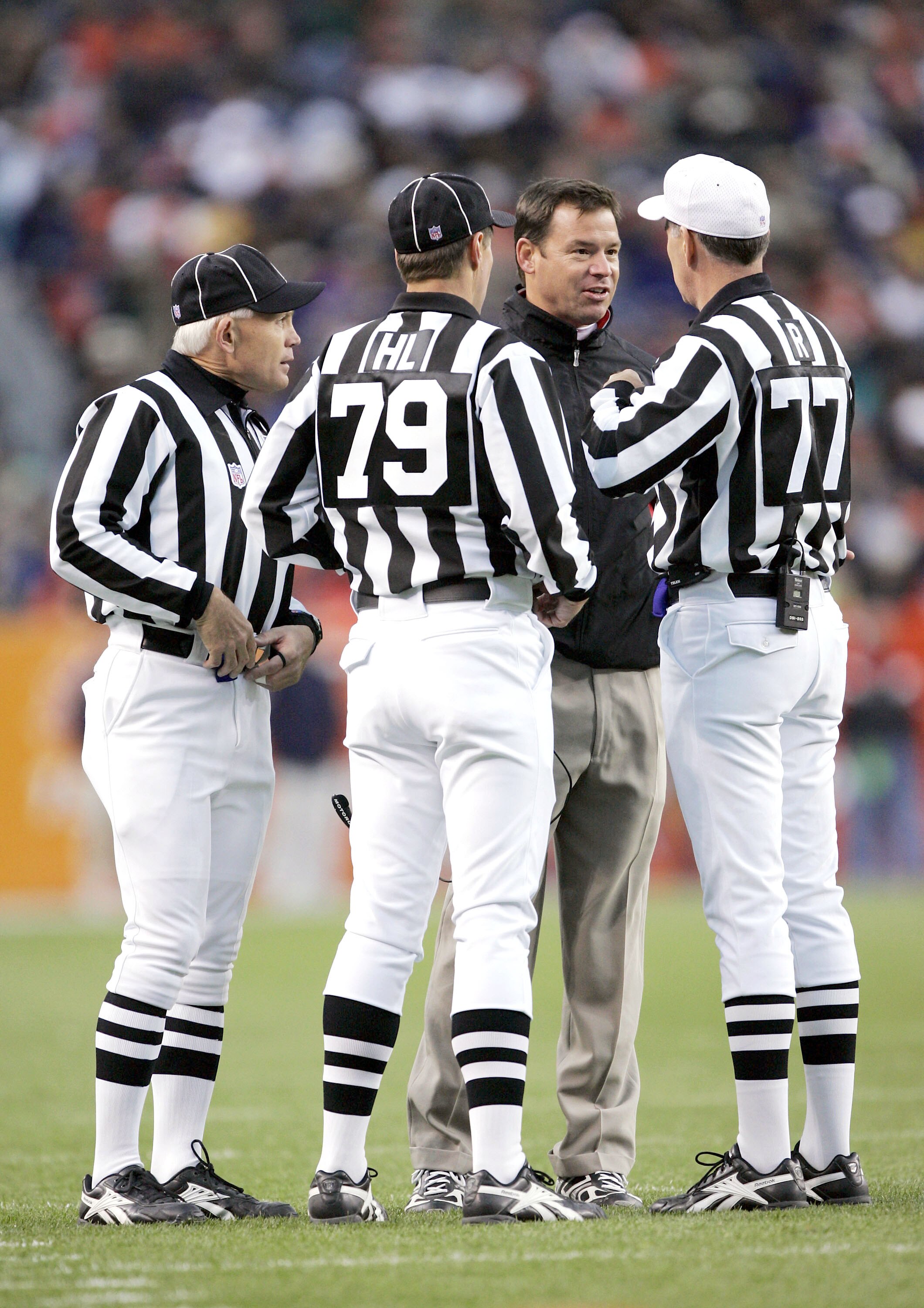DENVER - OCTOBER 31:  Head coach Jim Mora of the Atlanta Falcons questions referee Terry McAuley #77 and head linesman Kent Payne #79 after losing a challenge against the Denver Broncos in the third quarter on October 31, 2004 at Invesco Field at Mile Hig