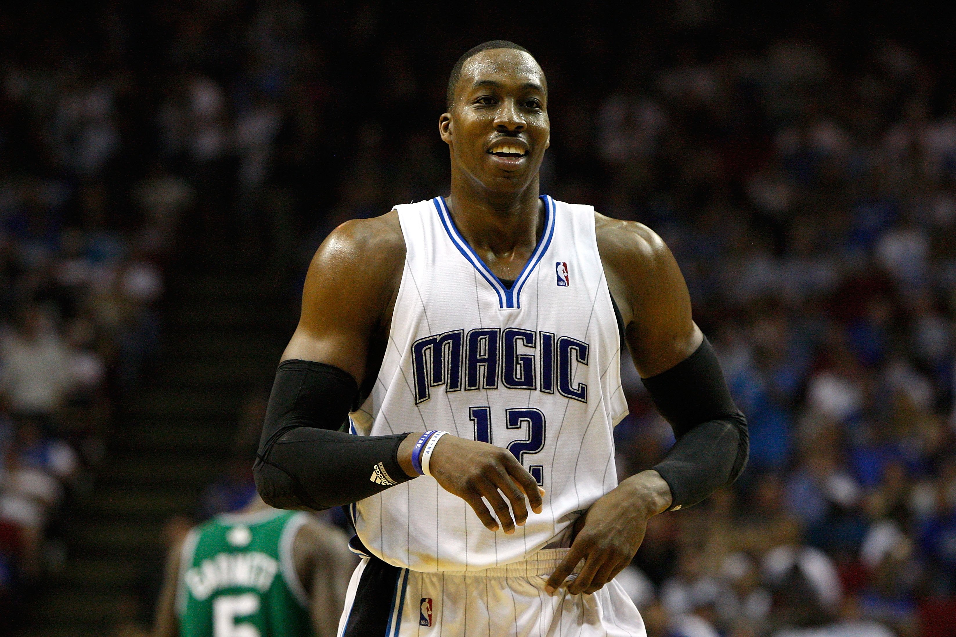 ORLANDO, FL - MAY 18:  Dwight Howard #12 of the Orlando Magic smiles as he looks on against the Boston Celtics in Game Two of the Eastern Conference Finals during the 2010 NBA Playoffs at Amway Arena on May 18, 2010 in Orlando, Florida.  NOTE TO USER: Use
