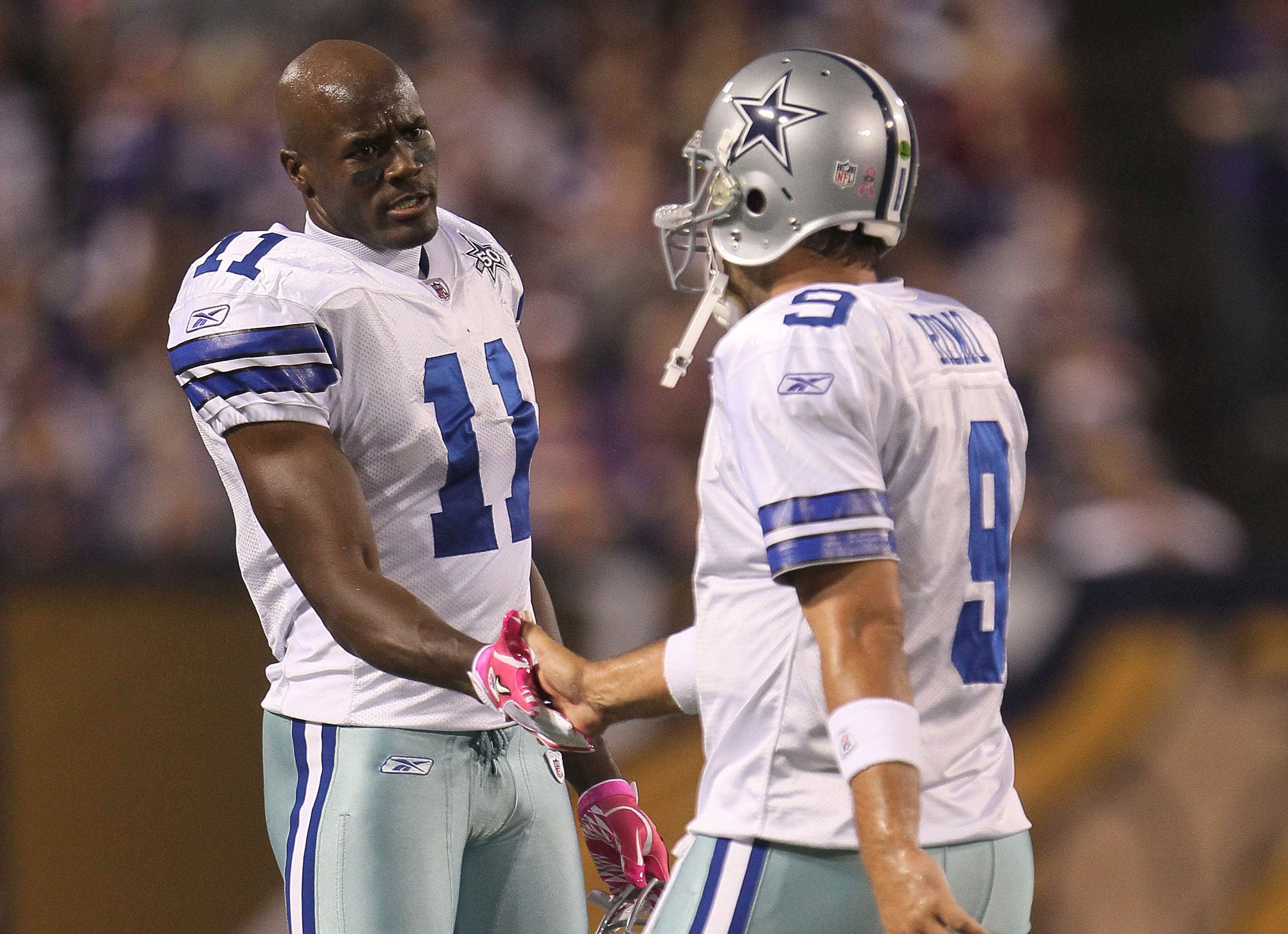 MINNEAPOLIS - OCTOBER 17:  Roy Williams #11 and Tony Romo #9 of the Dallas Cowboys shake hands during the game against the Minnesota Vikings at Mall of America Field on October 17, 2010 in Minneapolis, Minnesota.  (Photo by Jeff Gross/Getty Images)
