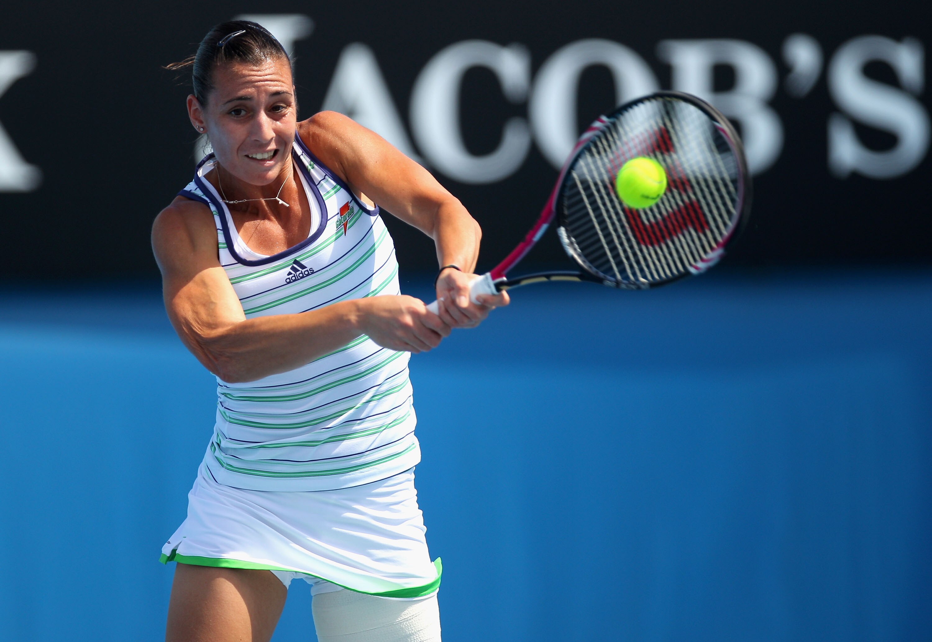 MELBOURNE, AUSTRALIA - JANUARY 20:  Flavia Pennetta of Italy plays a backhand in her second round match against Lourdes Dominguez Lino of Spain during day four of the 2011 Australian Open at Melbourne Park on January 20, 2011 in Melbourne, Australia.  (Ph