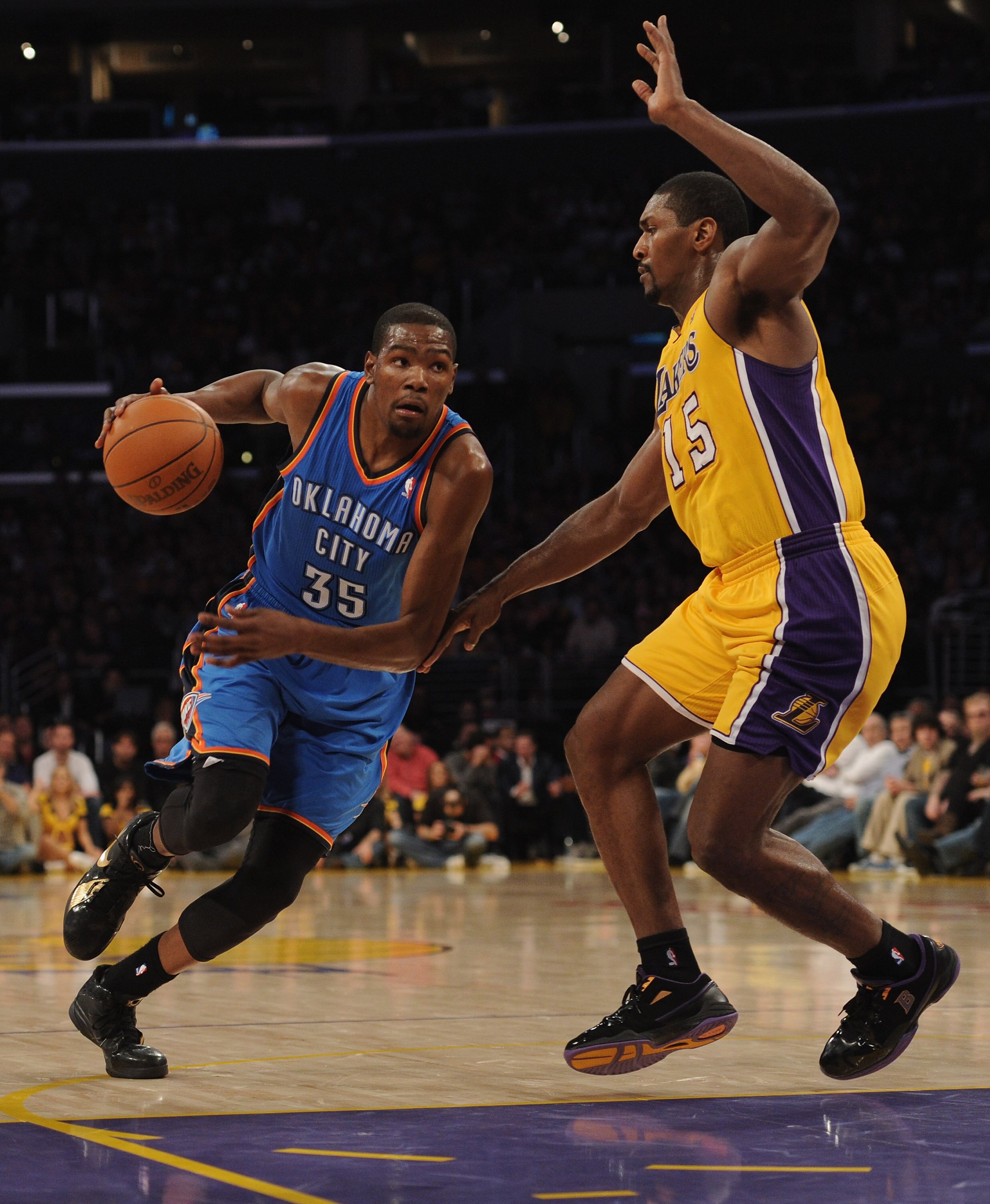 LOS ANGELES, CA - JANUARY 17:  Kevin Durant #35 of the Oklahoma City Thunder dribbles to the basket around Ron Artest #15 of the Los Angeles Lakers at the Staples Center on January 17, 2011 in Los Angeles, California.   NOTE TO USER: User expressly acknow