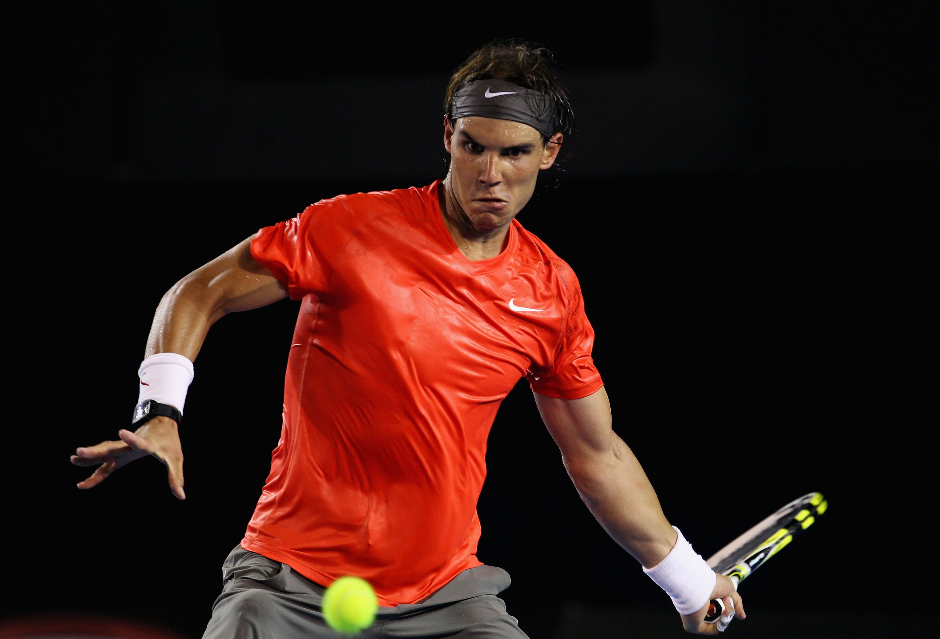 MELBOURNE, AUSTRALIA - JANUARY 22:  Rafael Nadal of Spain plays a forehand in his third round match against Bernard Tomic of Australia during day six of the 2011 Australian Open at Melbourne Park on January 22, 2011 in Melbourne, Australia.  (Photo by Jul