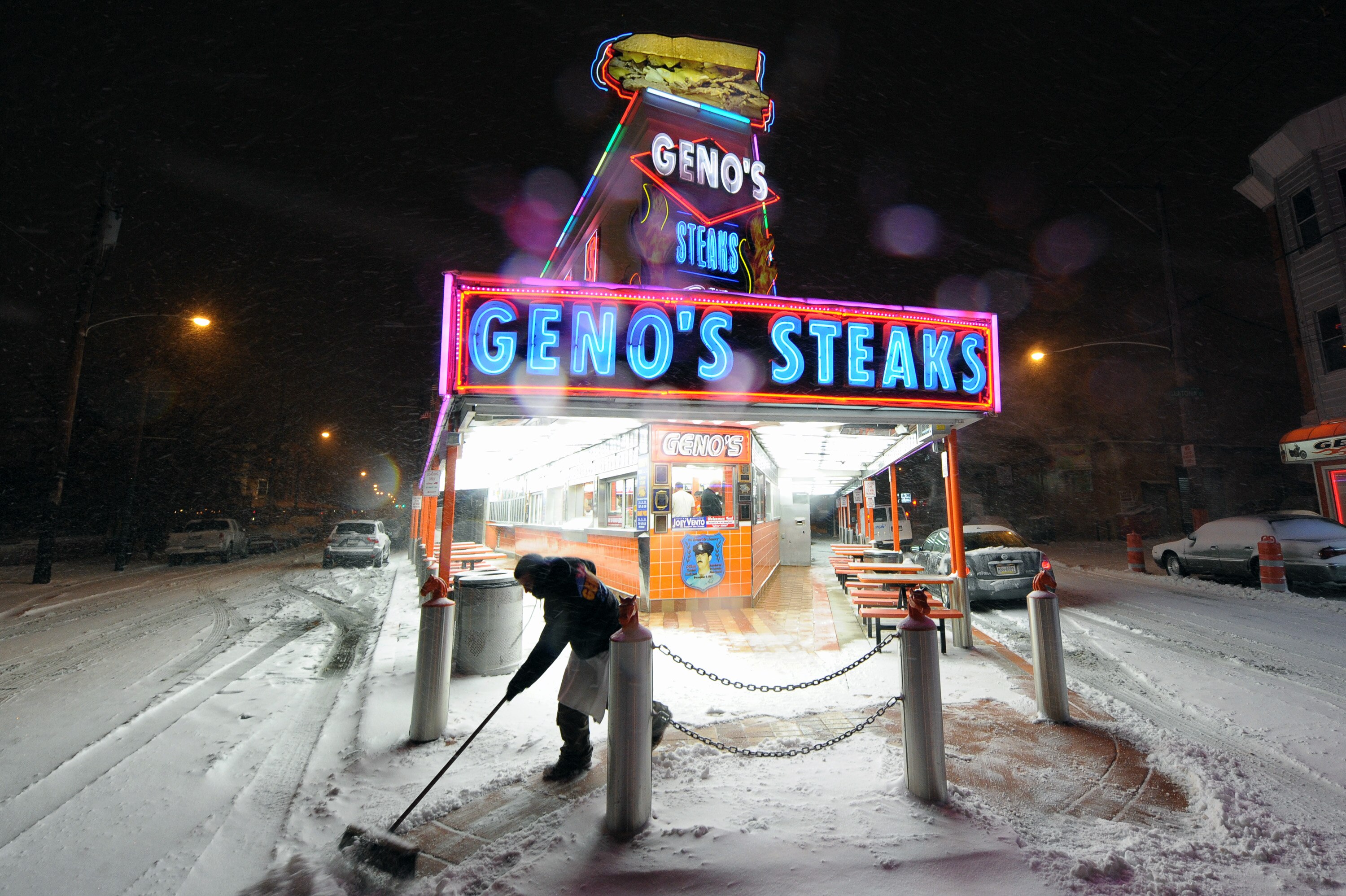 PHILADELPHIA - DECEMBER 26: A man cleans the sidewalk in front of Geno's Steaks during a blizzard on December 26, 2010 in Philadelphia, Pennsylvania. (Photo by Drew Hallowell/Getty Images)