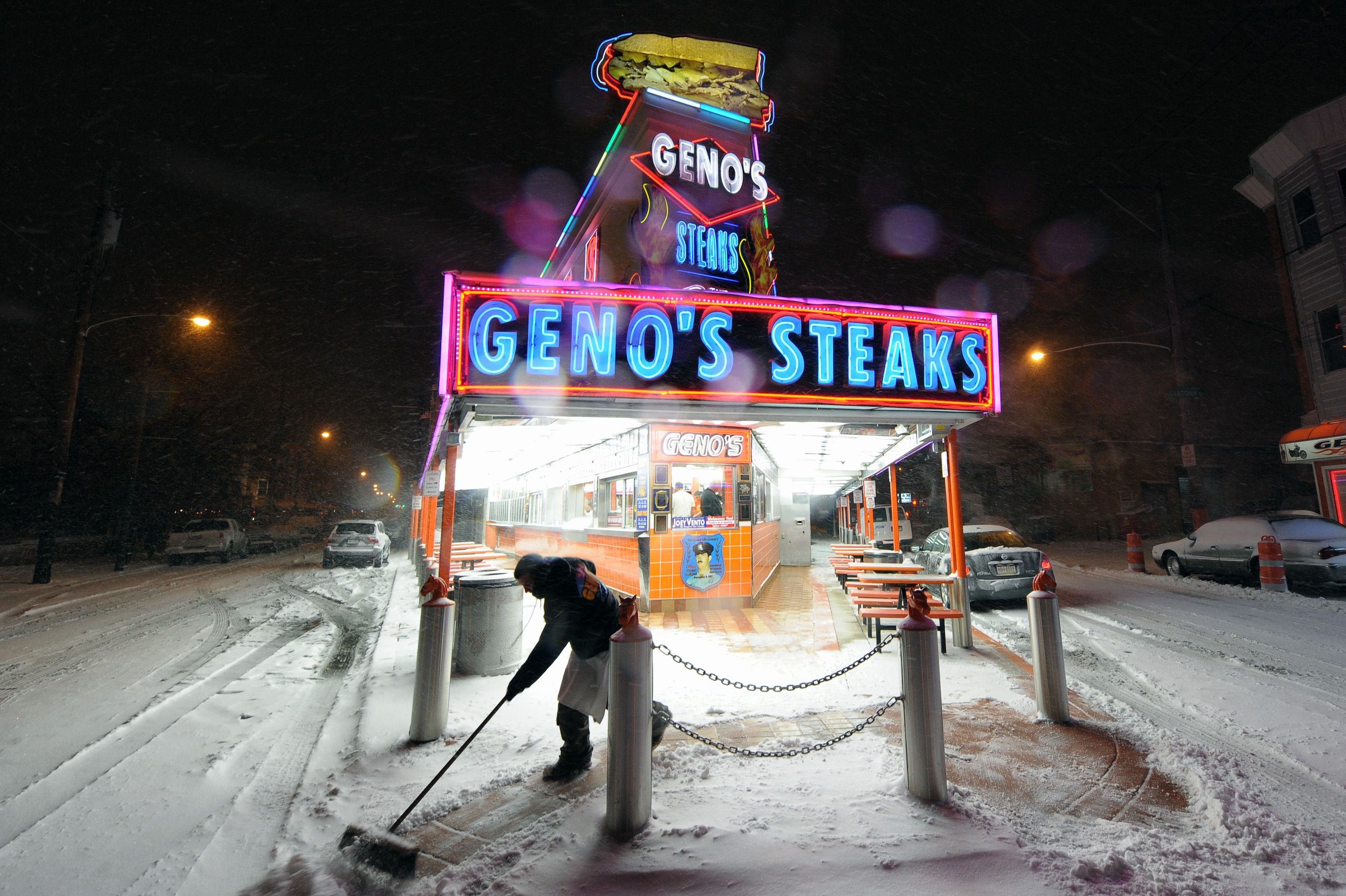 PHILADELPHIA - DECEMBER 26: A man cleans the sidewalk in front of Geno's Steaks during a blizzard on December 26, 2010 in Philadelphia, Pennsylvania. (Photo by Drew Hallowell/Getty Images)