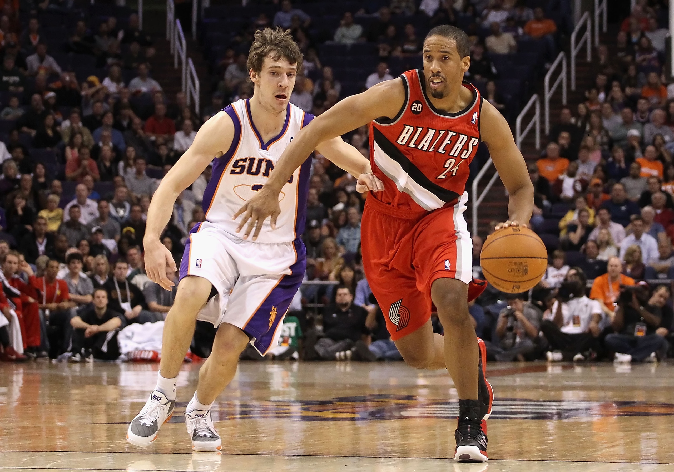 PHOENIX - DECEMBER 10: Andre Miller #24 of the Portland Trail Blazers drives with the ball past Goran Dragic #2 of the Phoenix Suns during the NBA game at US Airways Center on December 10, 2010 in Phoenix, Arizona. The Trail Blazers defeated the Suns 101 PHOENIX - DECEMBER 10: Andre Miller #24 of the Portland Trail Blazers drives with the ball past Goran Dragic #2 of the Phoenix Suns during the NBA game at US Airways Center on December 10, 2010 in Phoenix, Arizona. The Trail Blazers defeated the Suns 101