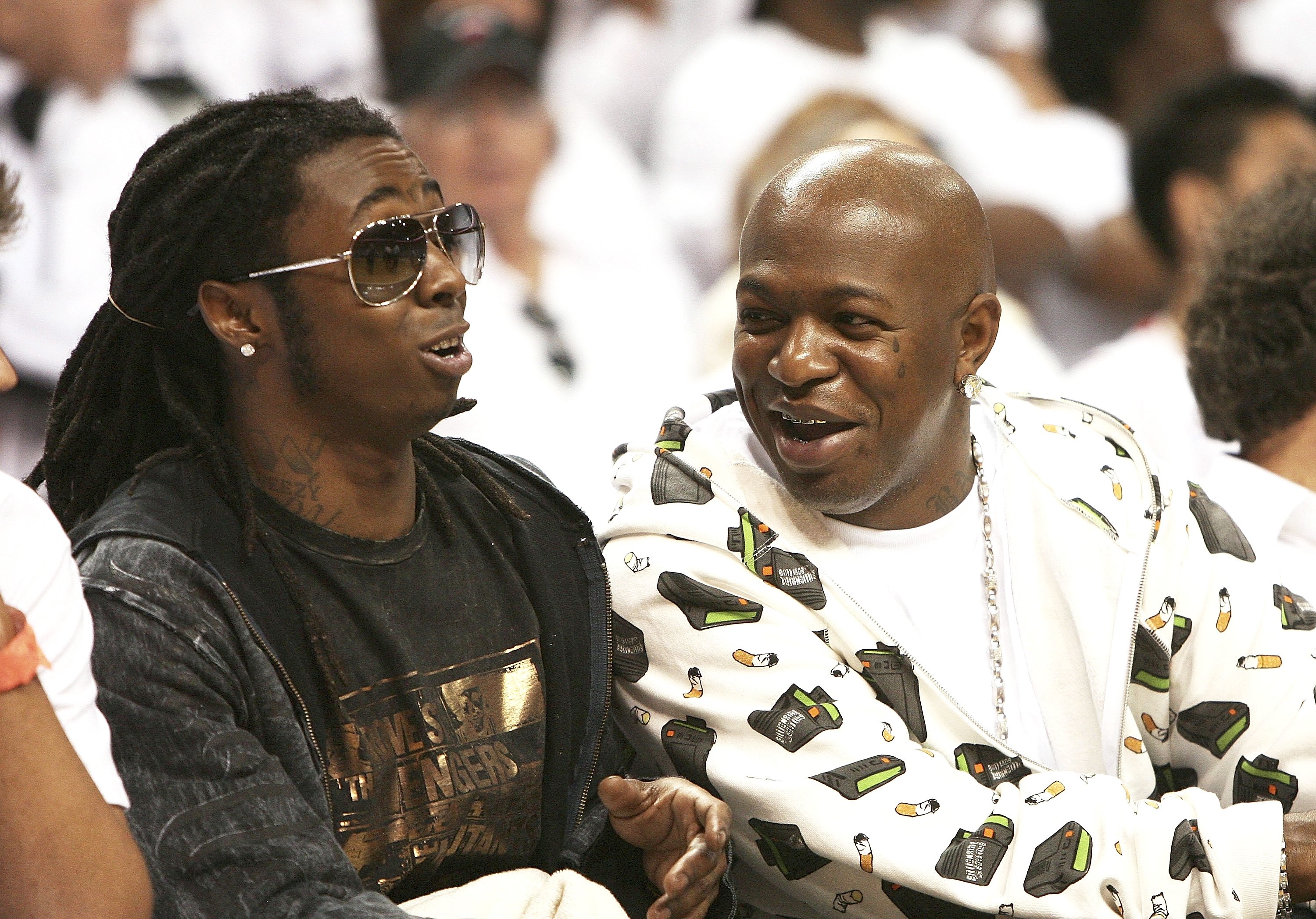 MIAMI - MAY 8: Recording artist Bryan 'Baby AKA Birdman' Williams (R) and rapper Lil Wayne watch as the New Jersey Nets take on the Miami Heat in game one of the Eastern Conference semifinals at American Airlines Arena on May 8, 2006 in Miami, Florida. Th