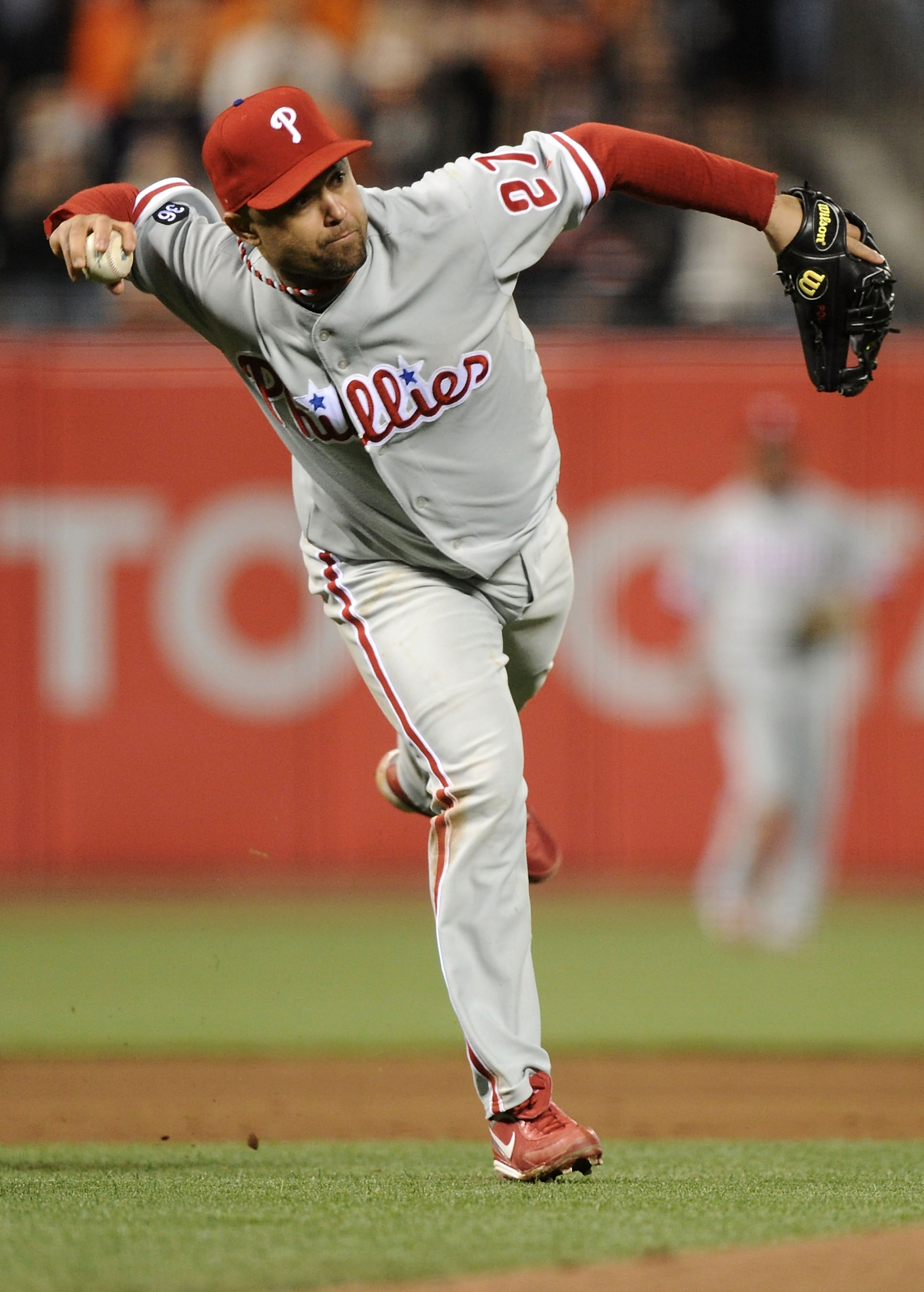 SAN FRANCISCO - OCTOBER 20:  Placido Polanco #27 of the Philadelphia Phillies throws out Edgar Renteria #16 of the San Francisco Giants after misplaying the ball in the fifth inning of Game Four of the NLCS during the 2010 MLB Playoffs at AT&T Park on Oct