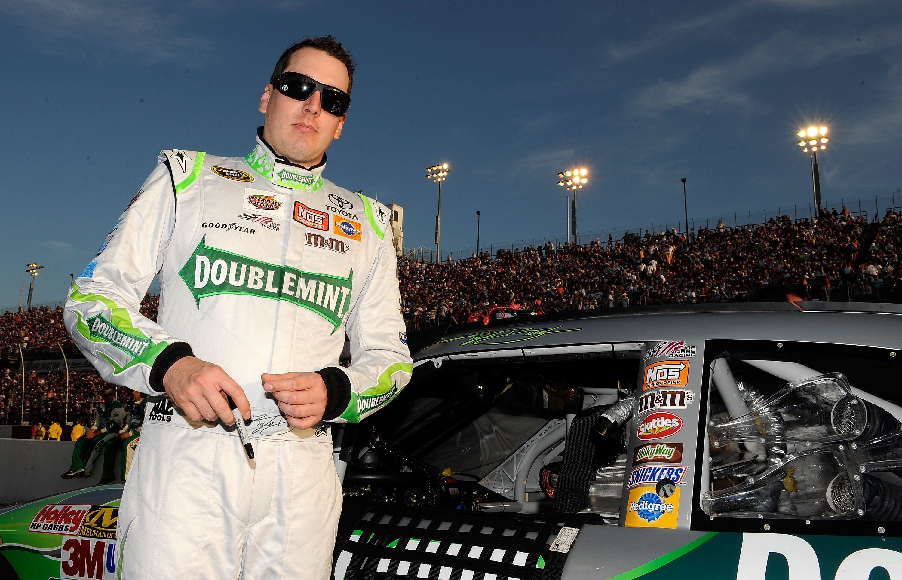 DARLINGTON, SC - MAY 08:  Kyle Busch, driver of the #18 Doublemint Toyota, stands on the grid prior to the start of the NASCAR Sprint Cup series SHOWTIME Southern 500 at Darlington Raceway on May 8, 2010 in Darlington, South Carolina.  (Photo by Rusty Jar