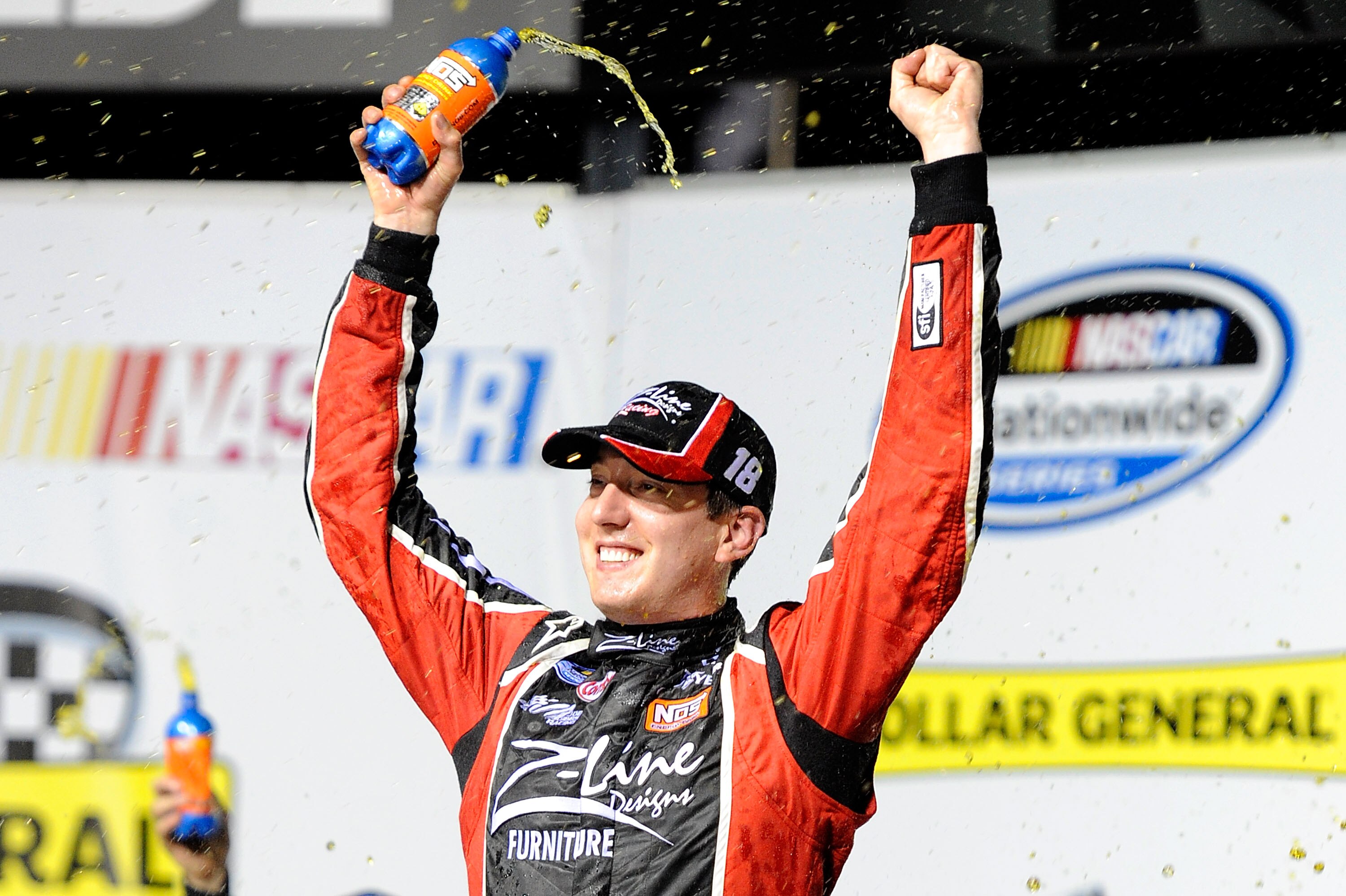 JOLIET, IL - JULY 09:  Kyle Busch, driver of the #18 Z-Line Designs Toyota, celebrates in victory lane after he won the NASCAR Nationwide Series Dollar General 300 Powered by Coca-Cola at the Chicagoland Speedway on July 9, 2010 in Joliet, Illinois.  (Pho