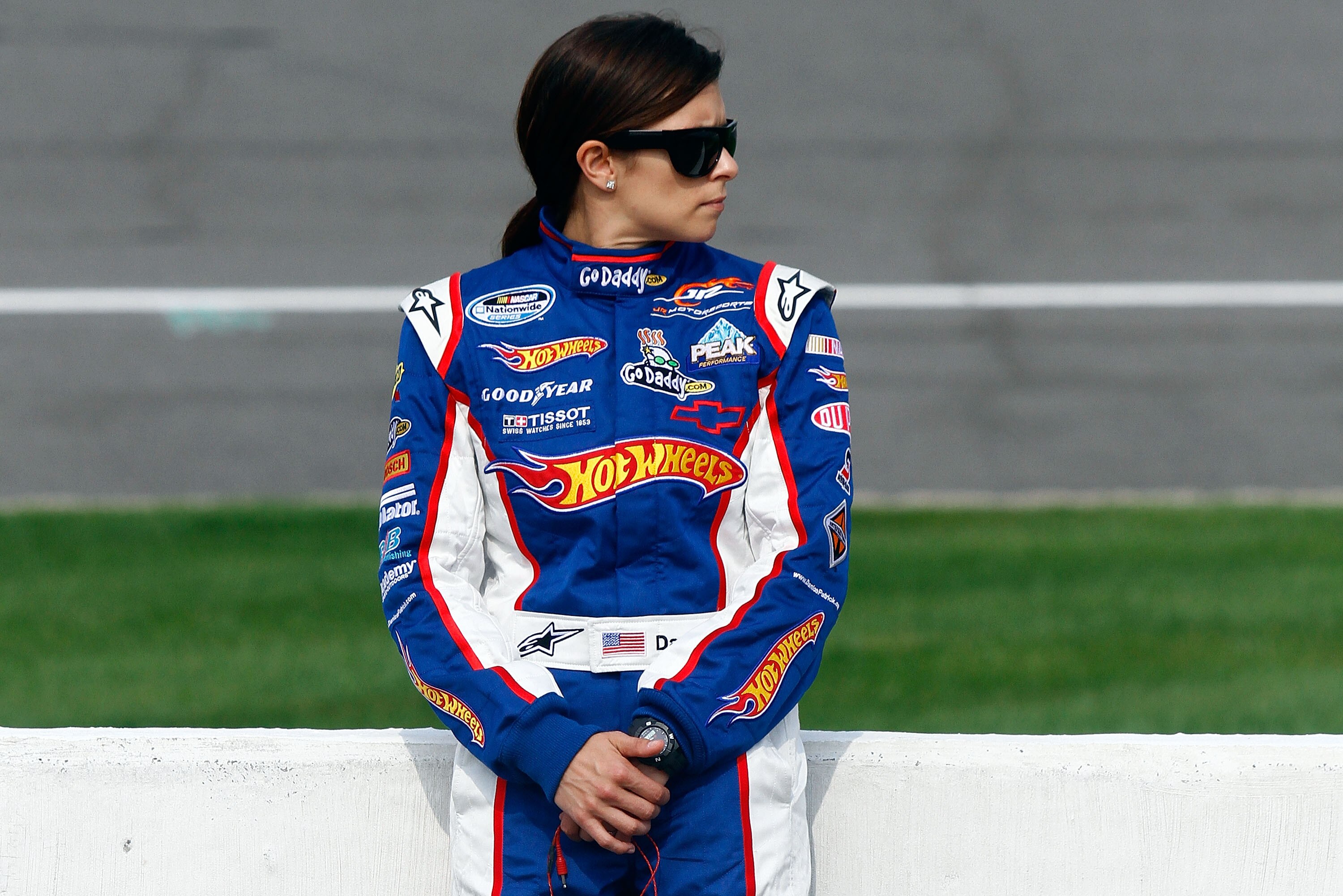 BROOKLYN, MI - AUGUST 14:  Danica Patrick, driver of the #7 Hot Wheels / GoDaddy.com Chevrolet, stands on the grid during qualifying for the NASCAR Nationwide Series CARFAX 250 at Michigan International Speedway on August 14, 2010 in Brooklyn, Michigan.