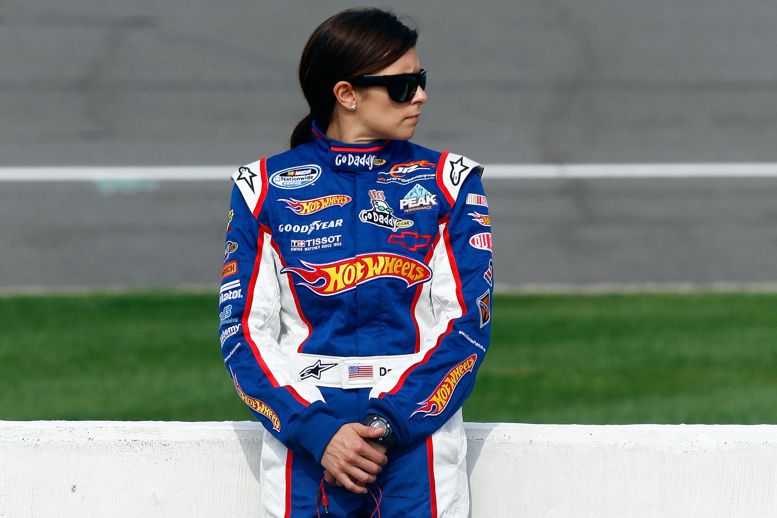BROOKLYN, MI - AUGUST 14:  Danica Patrick, driver of the #7 Hot Wheels / GoDaddy.com Chevrolet, stands on the grid during qualifying for the NASCAR Nationwide Series CARFAX 250 at Michigan International Speedway on August 14, 2010 in Brooklyn, Michigan.