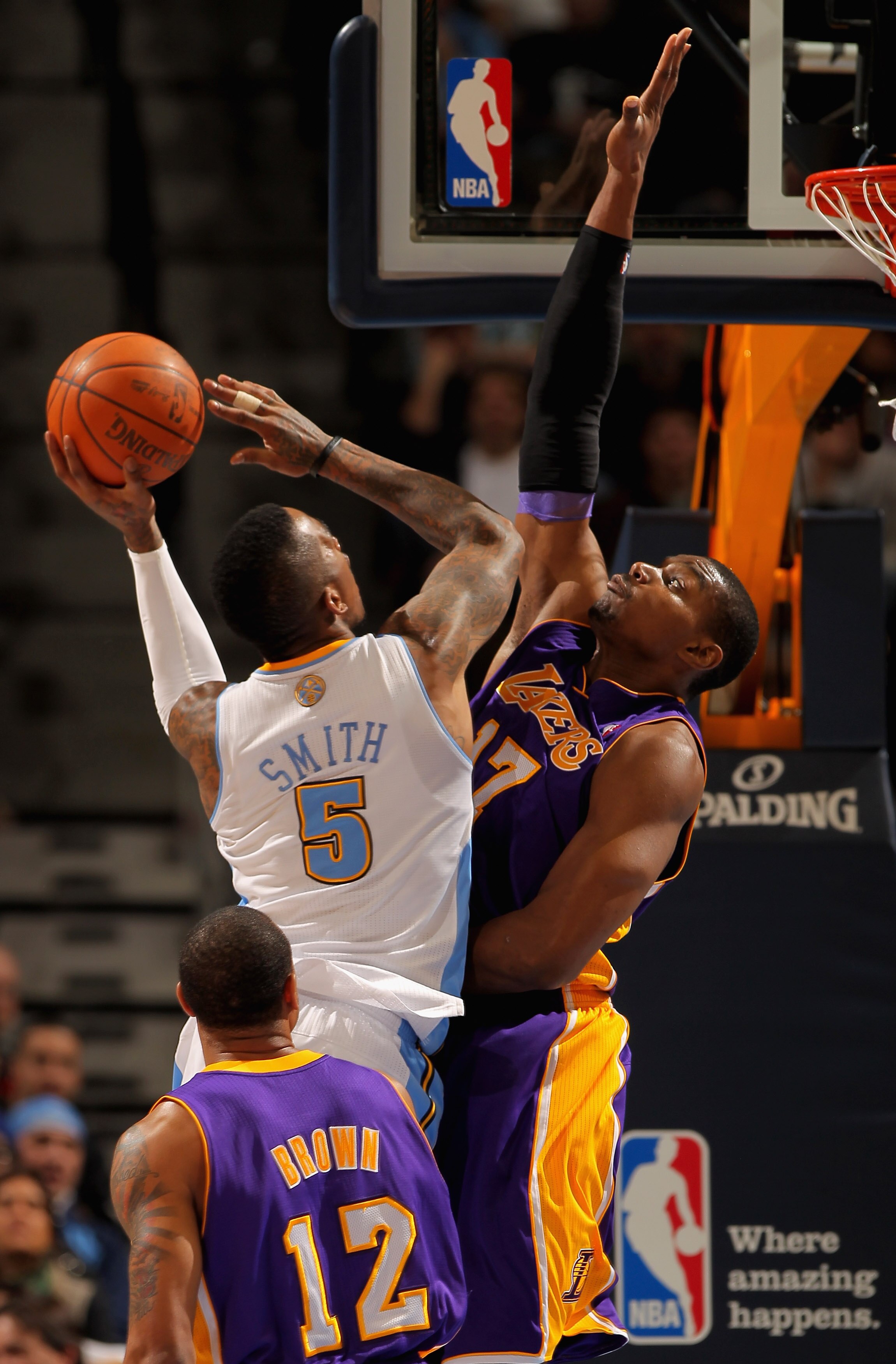 DENVER, CO - JANUARY 21:  J.R. Smith #5 of the Denver Nuggets takes a shot against Andrew Bynum #17 of the Los Angeles Lakers at the Pepsi Center on January 21, 2011 in Denver, Colorado. NOTE TO USER: User expressly acknowledges and agrees that, by downlo