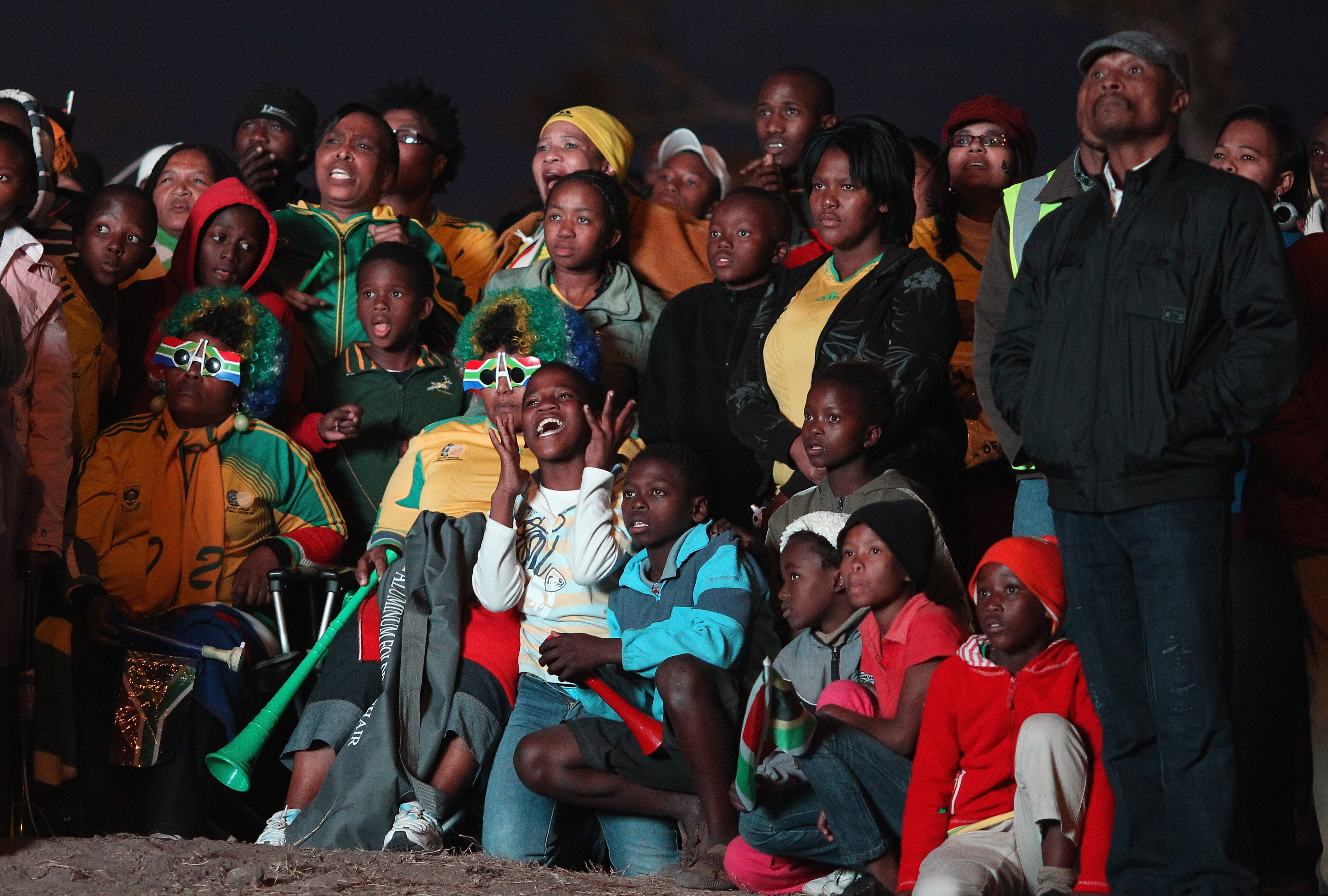 PORT ELIZABETH, SOUTH AFRICA - JUNE 22:  South African fans watch the match against France in the last of their group stage matches at the Motherwell Township on June 22, 2010 in Port Elizabeth, South Africa. Despite a strong performance beating France 2-