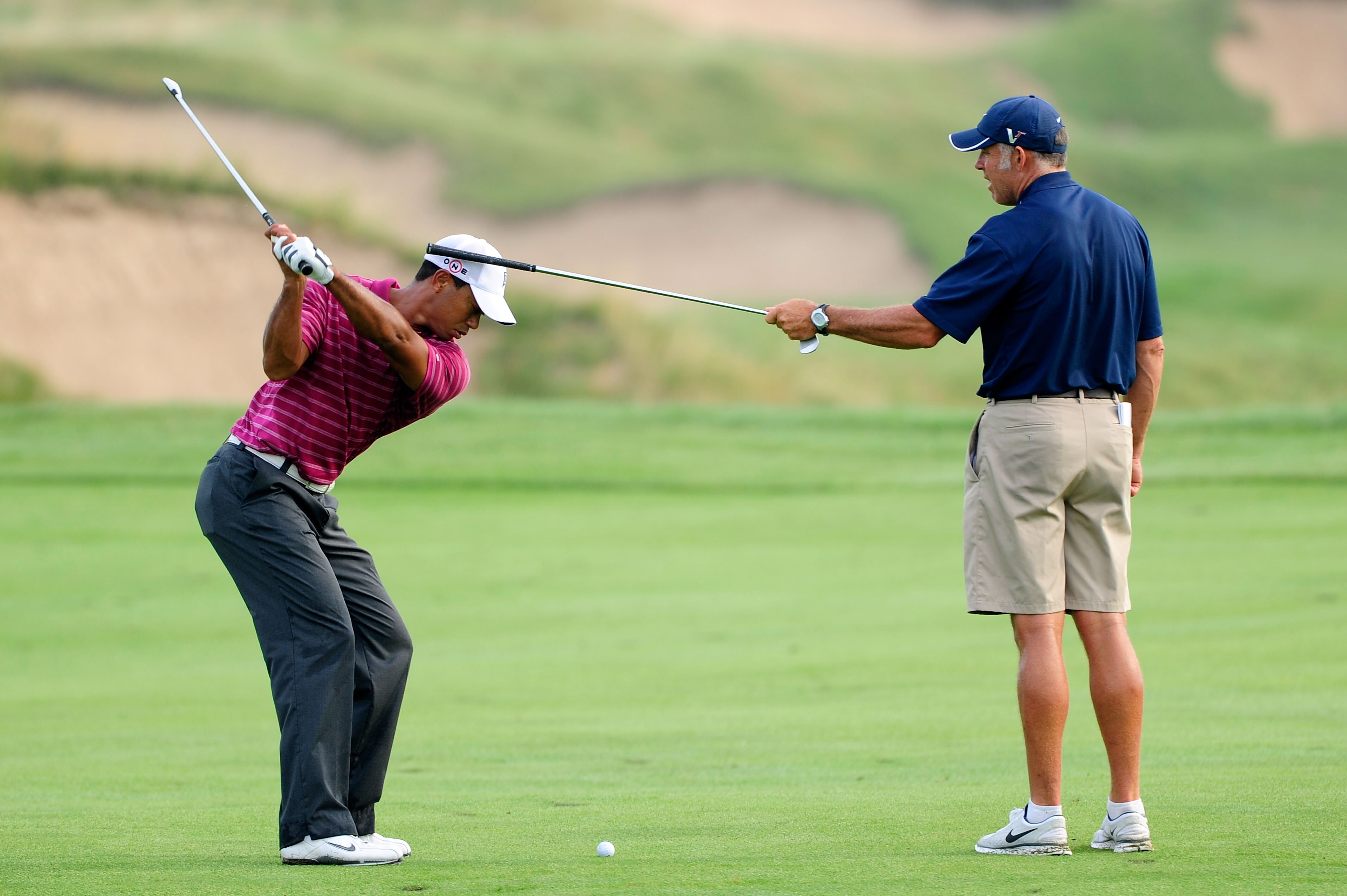 KOHLER, WI - AUGUST 10:  Tiger Woods works on his golf swing with his caddie Steve Williams (R) during a practice round prior to the start of the 92nd PGA Championship on the Straits Course at Whistling Straits on August 10, 2010 in Kohler, Wisconsin.  (P