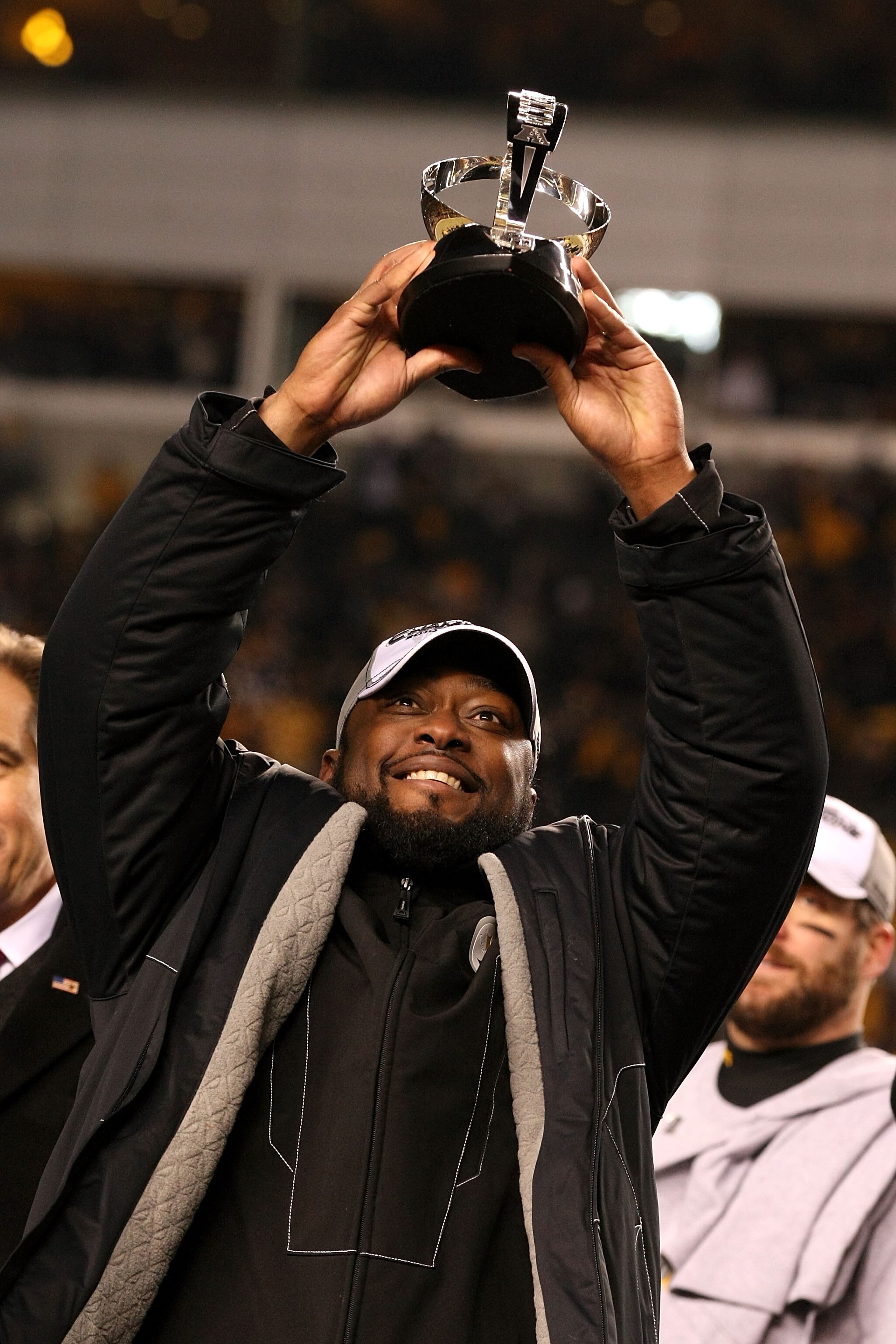 PITTSBURGH, PA - JANUARY 23:  Head coach Mike Tomlin of the Pittsburgh Steelers holds up the Lamar Hunt trophy after the Steelers defeated the New York Jets 24 to 19 in the 2011 AFC Championship game at Heinz Field on January 23, 2011 in Pittsburgh, Penns