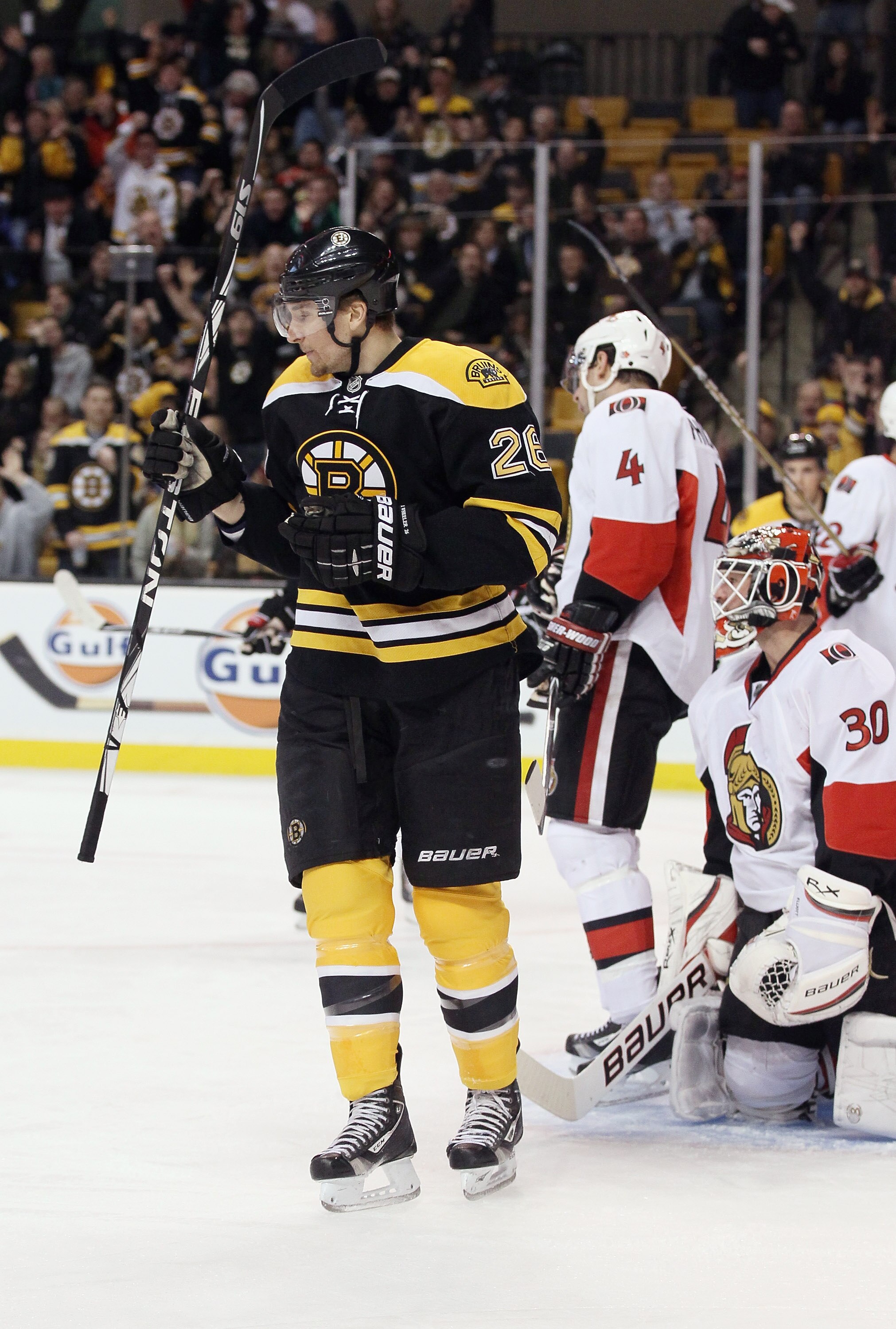 BOSTON, MA - JANUARY 11:  Blake Wheeler #26 of the Boston Bruins celebrates his goal as Brian Elliott #30 and Chris Phillips #4 of the Ottawa Senators stand by on January 11, 2011 at the TD Garden in Boston, Massachusetts.  (Photo by Elsa/Getty Images)