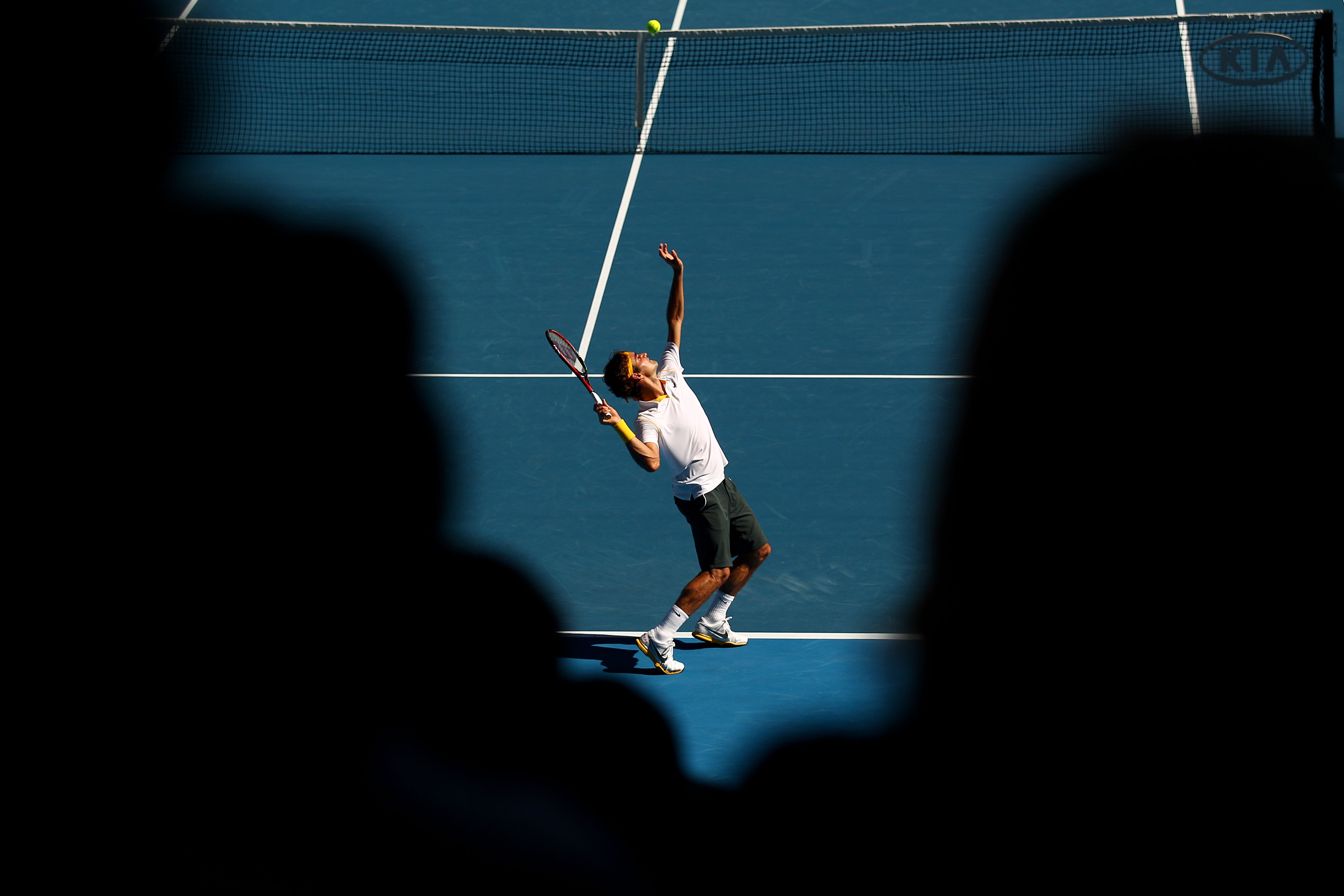 MELBOURNE, AUSTRALIA - JANUARY 23:  Roger Federer of Switzerland serves in his fourth round match against Tommy Robredo of Spain during day seven of the 2011 Australian Open at Melbourne Park on January 23, 2011 in Melbourne, Australia.  (Photo by Ryan Pi