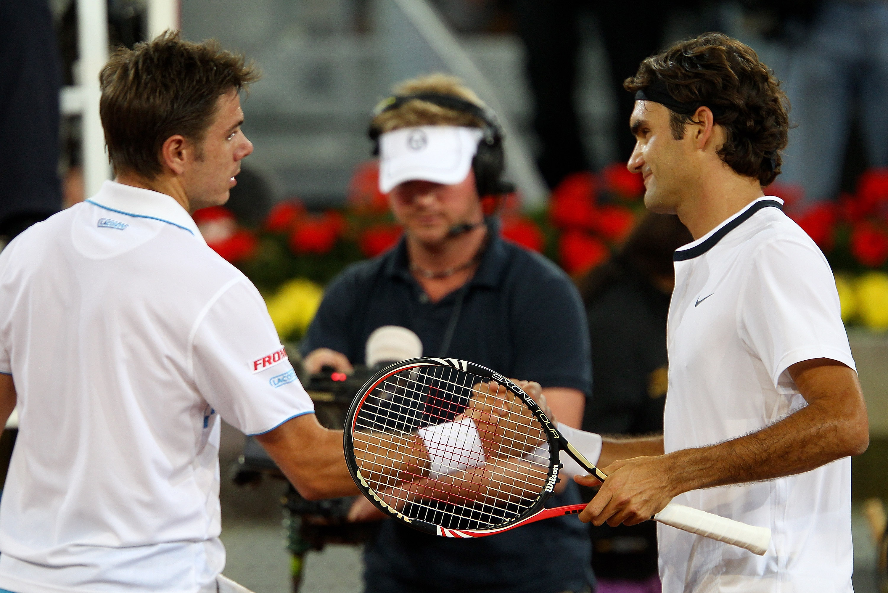 MADRID, SPAIN - MAY 13:  Roger Federer of Switzerland shakes hands at the net after his straight sets victory against Stanislas Wawrinka of Switzerland in their third round match during the Mutua Madrilena Madrid Open tennis tournament at the Caja Magica