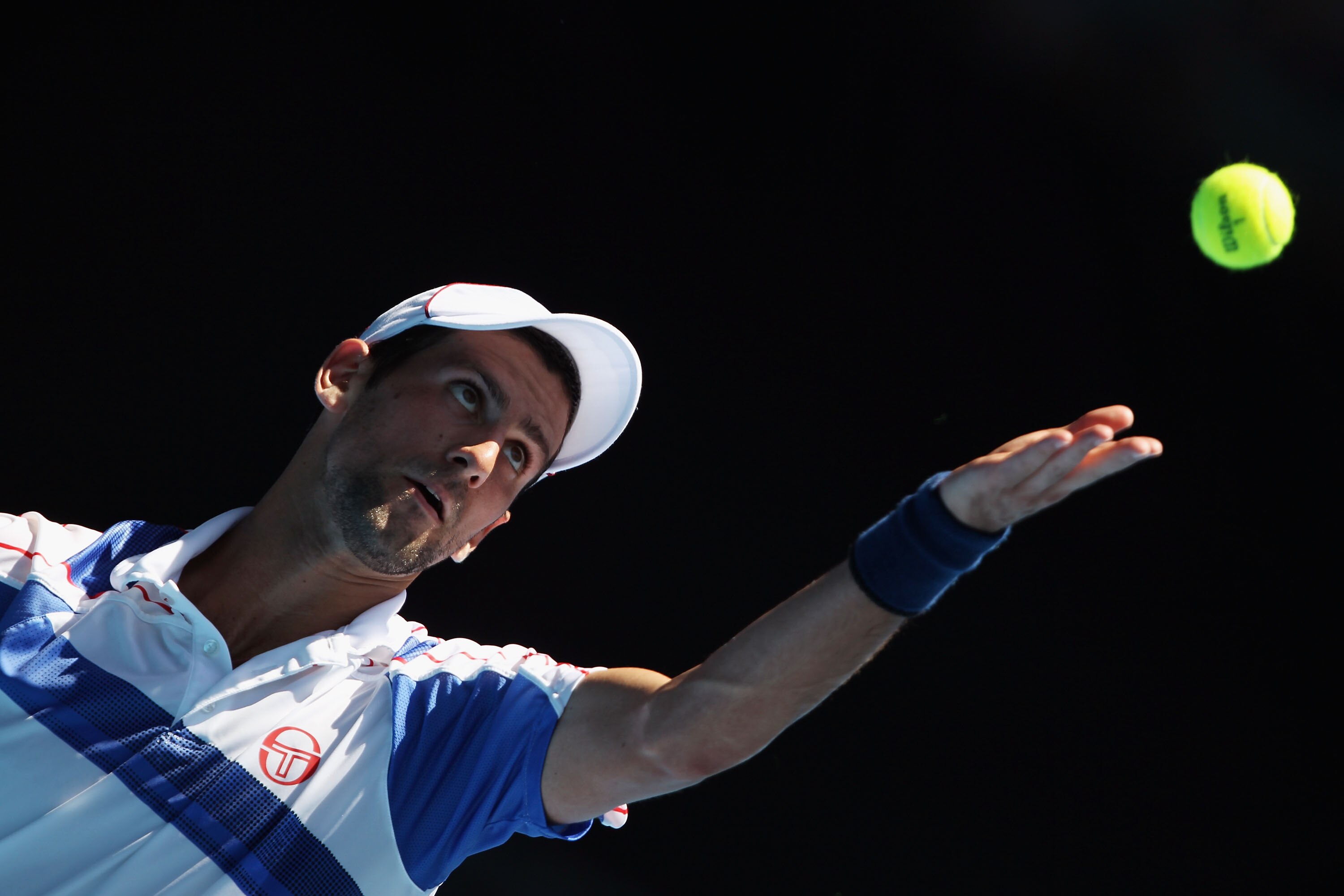 MELBOURNE, AUSTRALIA - JANUARY 23:  Novak Djokovic of Serbia plays a serves in his fourth round match against Nicolas Almagro of Spain during day seven of the 2011 Australian Open at Melbourne Park on January 23, 2011 in Melbourne, Australia.  (Photo by C