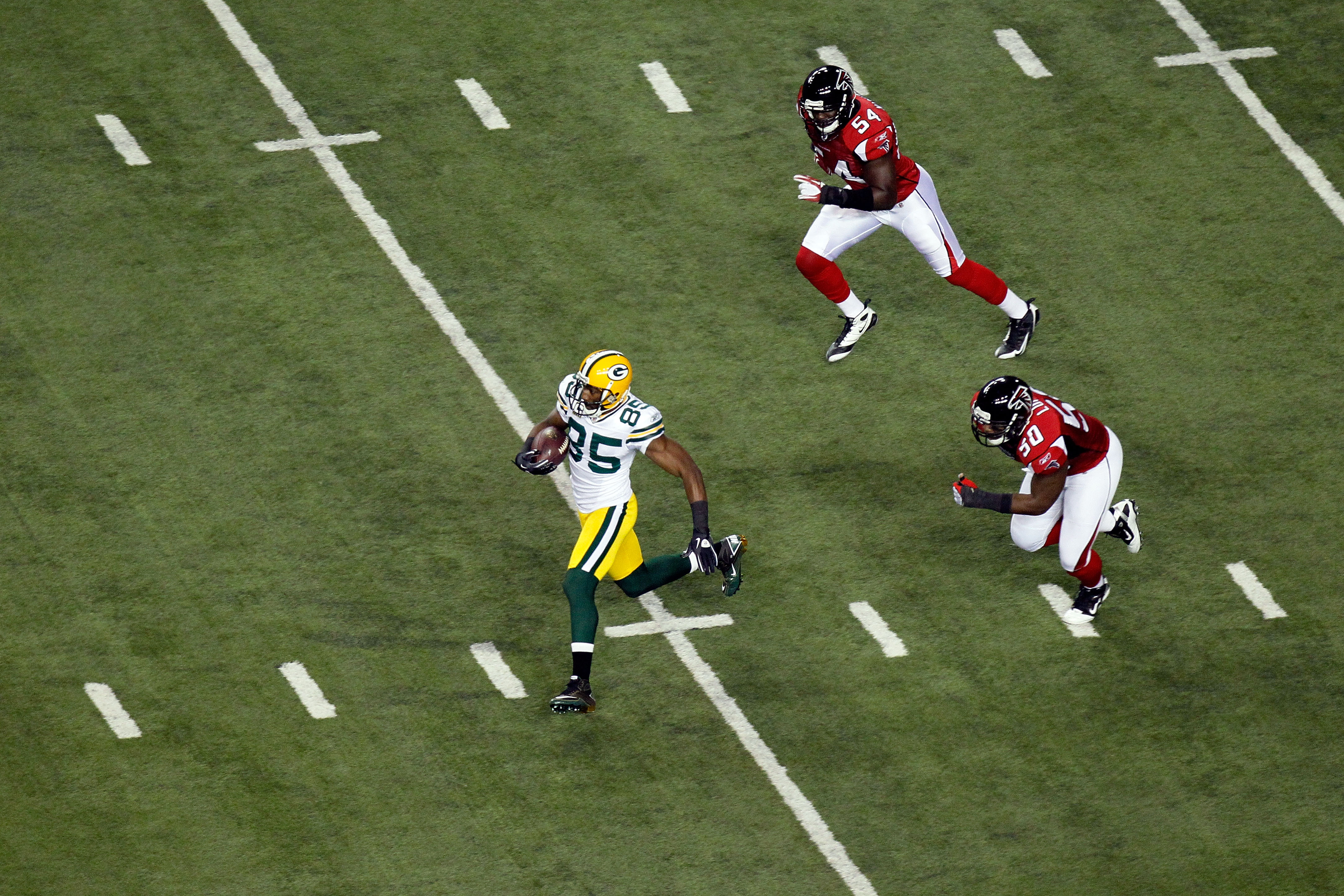 ATLANTA, GA - JANUARY 15:  Greg Jenning #85 of the Green Bay Packers runs for yards after the catch against the Atlanta Falcons during their 2011 NFC divisional playoff game at Georgia Dome on January 15, 2011 in Atlanta, Georgia. The Packers won 48-21. (
