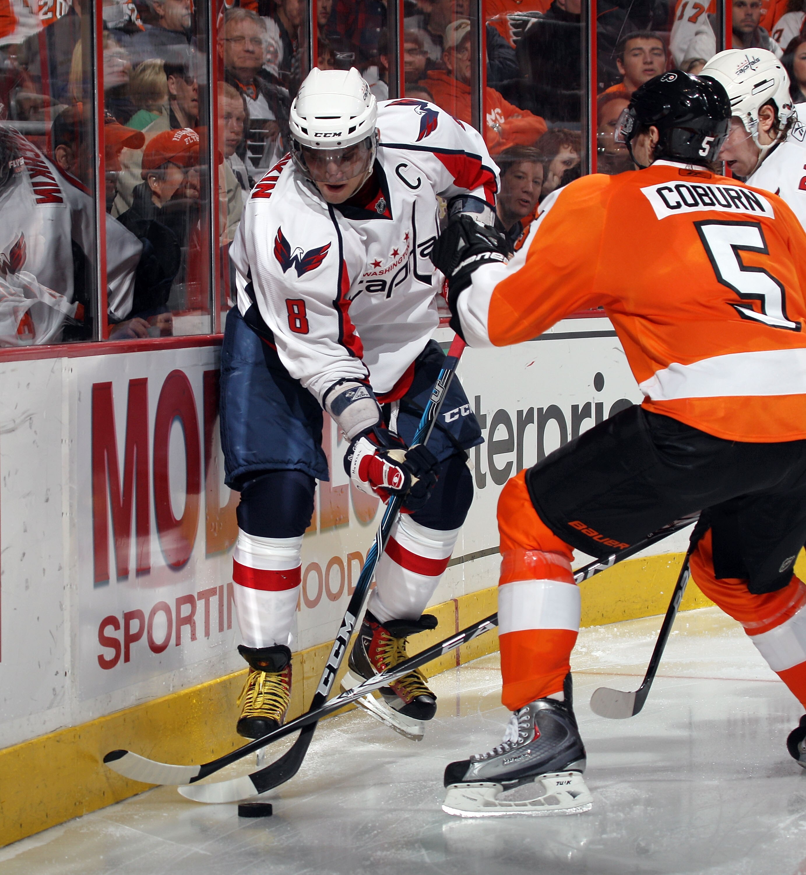 PHILADELPHIA, PA - JANUARY 18: Braydon Coburn #5 of the Philadelphia Flyers checks Alex Ovechkin #8 of the Washington Capitals at the Wells Fargo Center on January 18, 2011 in Philadelphia, Pennsylvania. The Flyers defeated the Capitals 3-2 in overtime. (