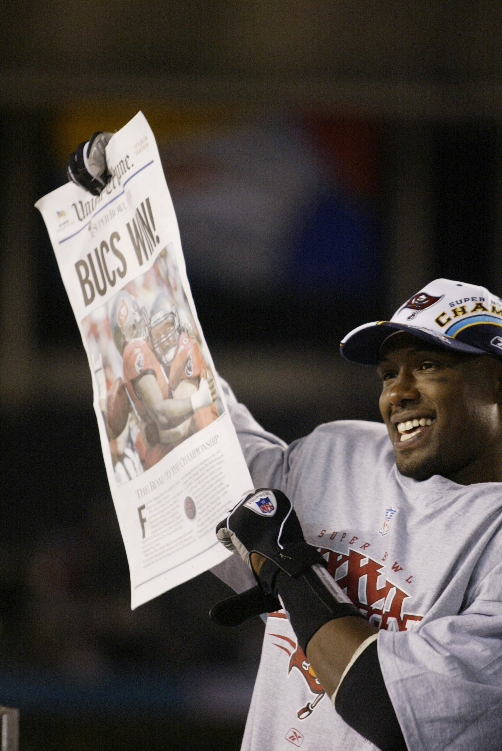 SAN DIEGO - JANUARY 26:  Most Valuable Player safety Dexter Jackson #34 of the Tampa Bay Buccaneers holds a newspaper proclaiming that his team defeated the Oakland Raiders in the Super Bowl XXXVII at Qualcomm Stadium on January 26, 2003 in San Diego, Cal
