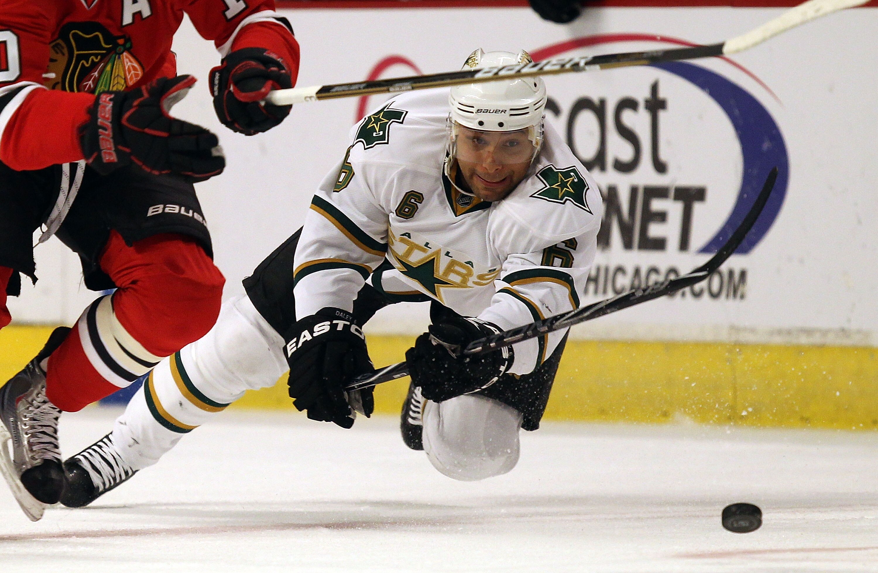 CHICAGO, IL - JANUARY 05: Trevor Daley #6 of the Dallas Stars falls to ice after trying to knock the puck away from Patrick Sharp of the Chicago Blackhawks at the United Center on January 5, 2011 in Chicago, Illinois. (Photo by Jonathan Daniel/Getty Image