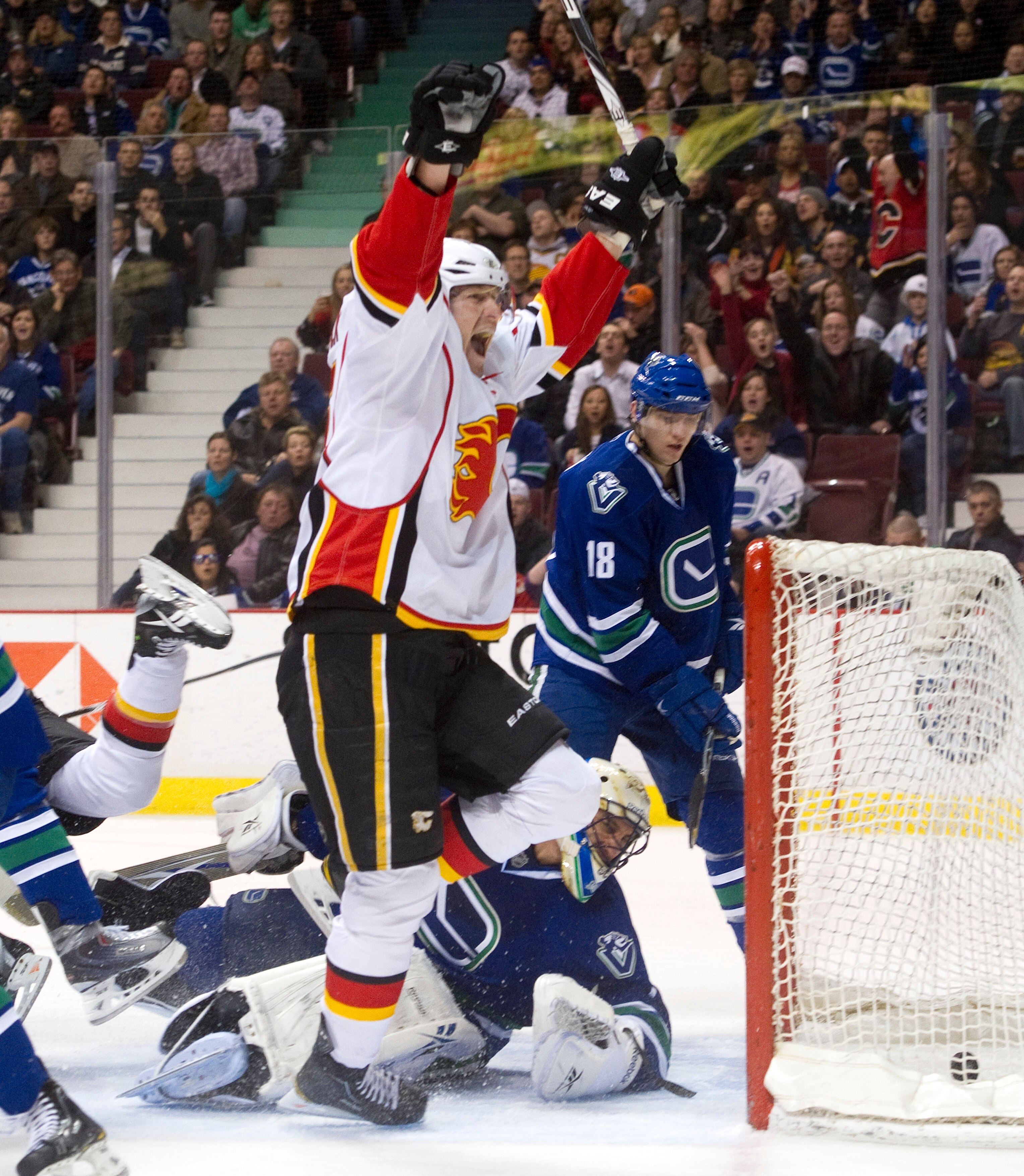 VANCOUVER, CANADA - JANUARY 22: Tim Jackman #15 of the Calgary Flames celebrates after scoring against goalie Roberto Luongo #1 of the Vancouver Canucks during the third period in NHL action on January 22, 2011 at Rogers Arena in Vancouver, British Columb