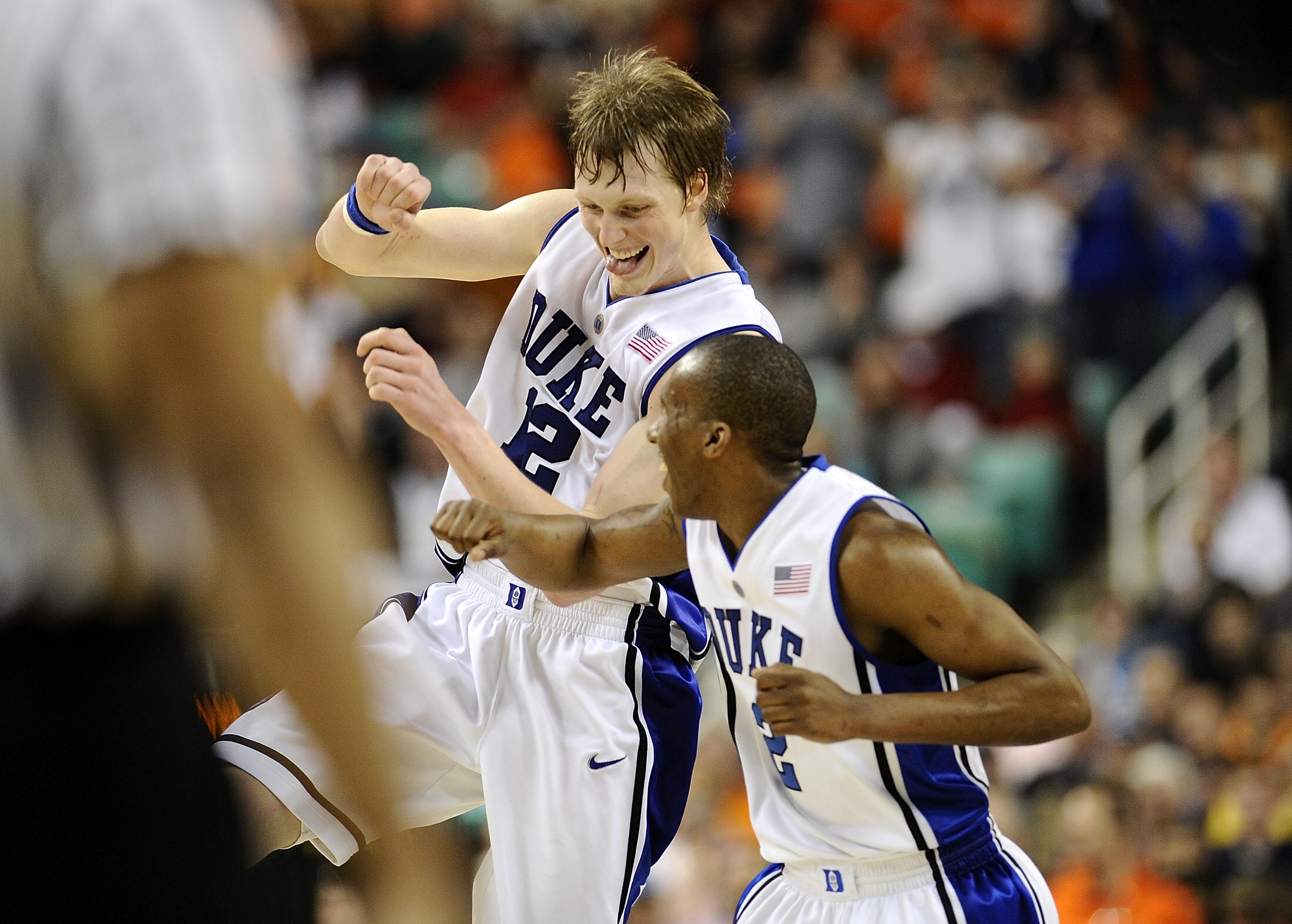GREENSBORO, NC - MARCH 12:  Kyle Singler #12 and Nolan Smith #2 of the Duke Blue Devils celebrate during win over the University of Virginia Cavaliers in their quarterfinal game in the 2010 ACC Men's Basketball Tournament at the Greensboro Coliseum on Mar