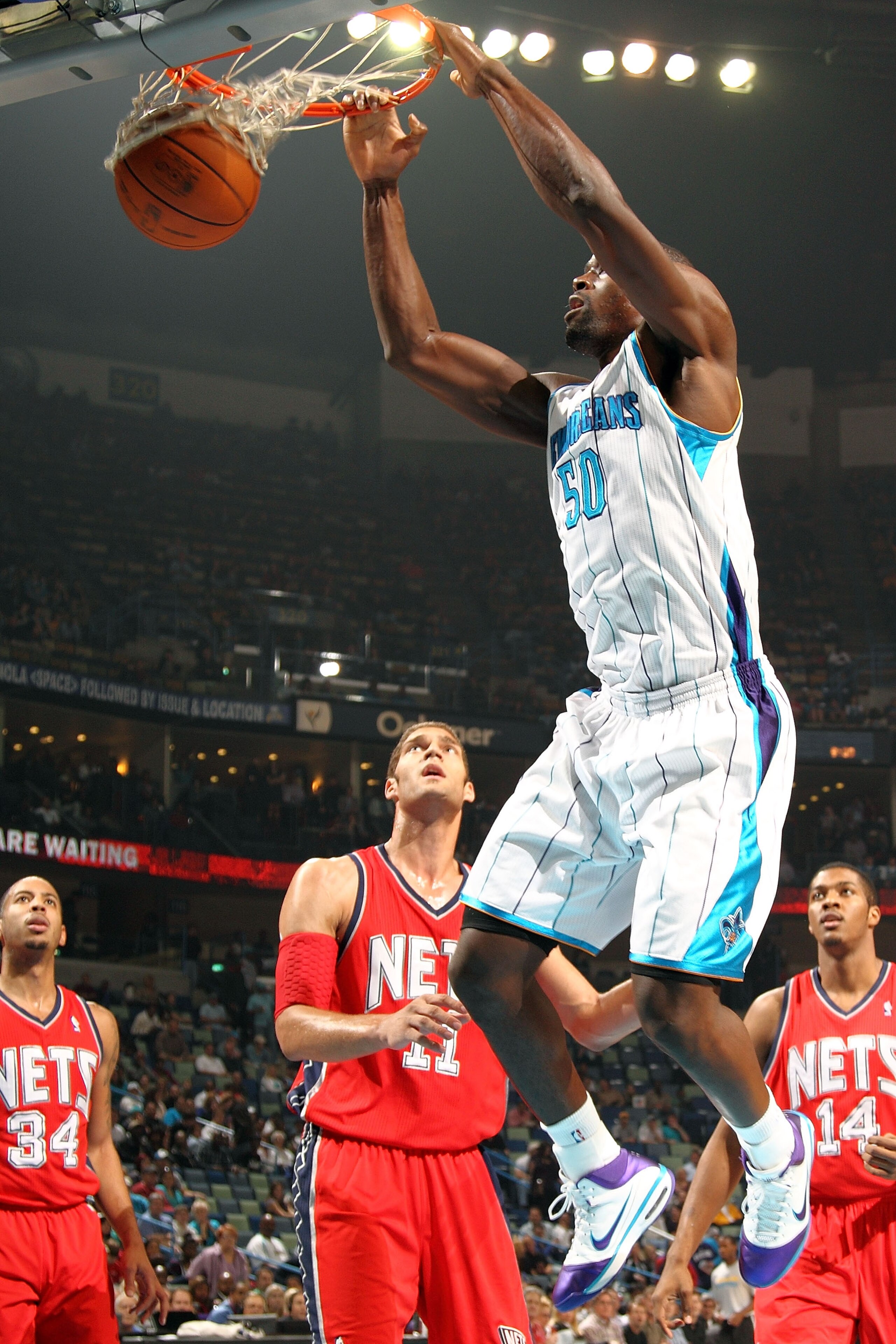 NEW ORLEANS, LA - DECEMBER 22: Emeka Okafor #50 of the New Orleans Hornets dunks the ball over Brook Lopez #11 of the New Jersey Nets at the New Orleans Arena on December 22, 2010 in New Orleans, Louisiana. NOTE TO USER: User expressly acknowledges and NEW ORLEANS, LA - DECEMBER 22: Emeka Okafor #50 of the New Orleans Hornets dunks the ball over Brook Lopez #11 of the New Jersey Nets at the New Orleans Arena on December 22, 2010 in New Orleans, Louisiana. NOTE TO USER: User expressly acknowledges and