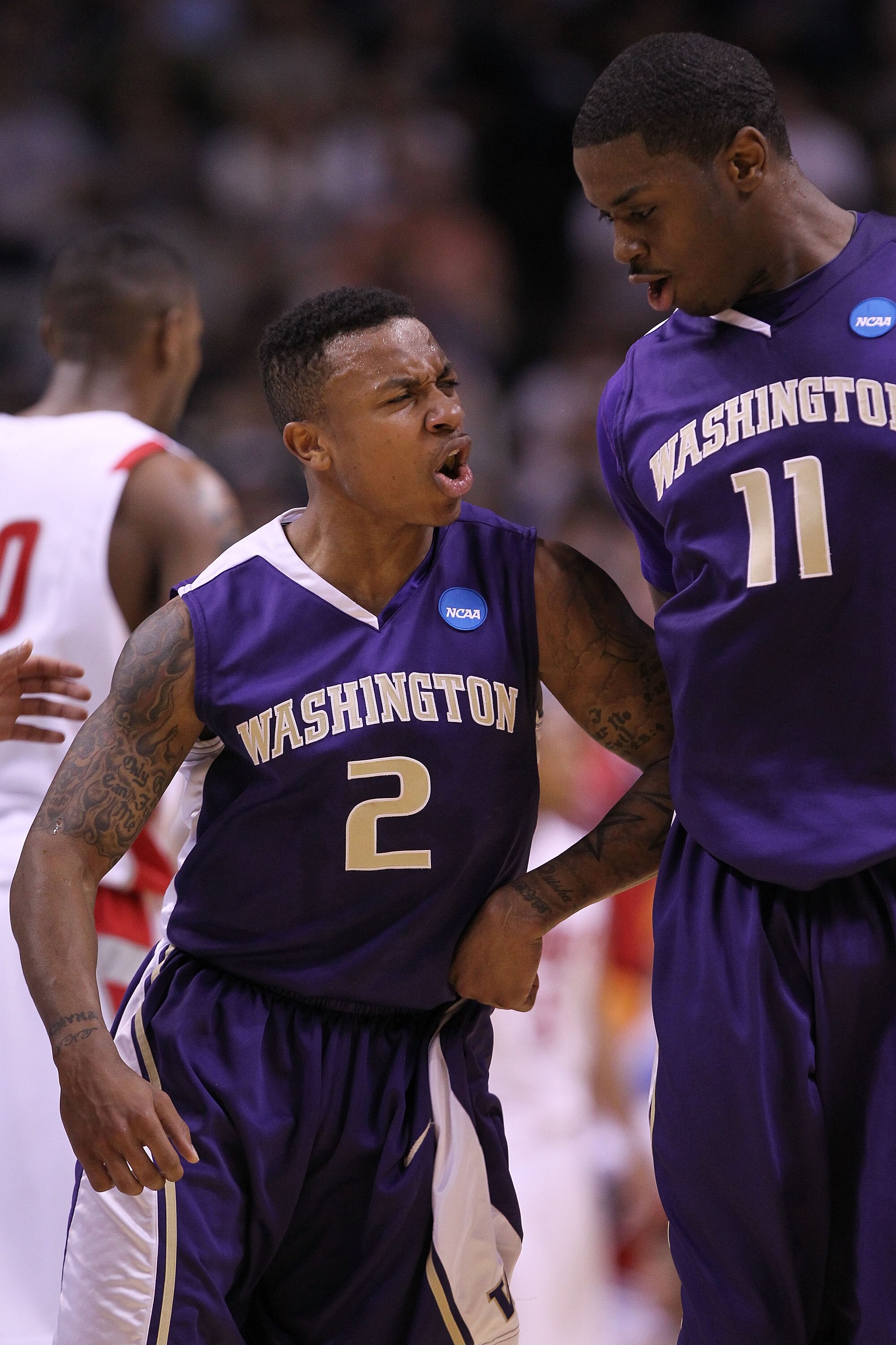 SAN JOSE, CA - MARCH 20:  Guard Isaiah Thomas #2 of the Washington Huskies celebrates with Matthew Bryan-Amaning #11 after a three point basket to give the Huskies a 10 point lead against the New Mexico Lobos in the second round of the 2010 NCAA men's bas