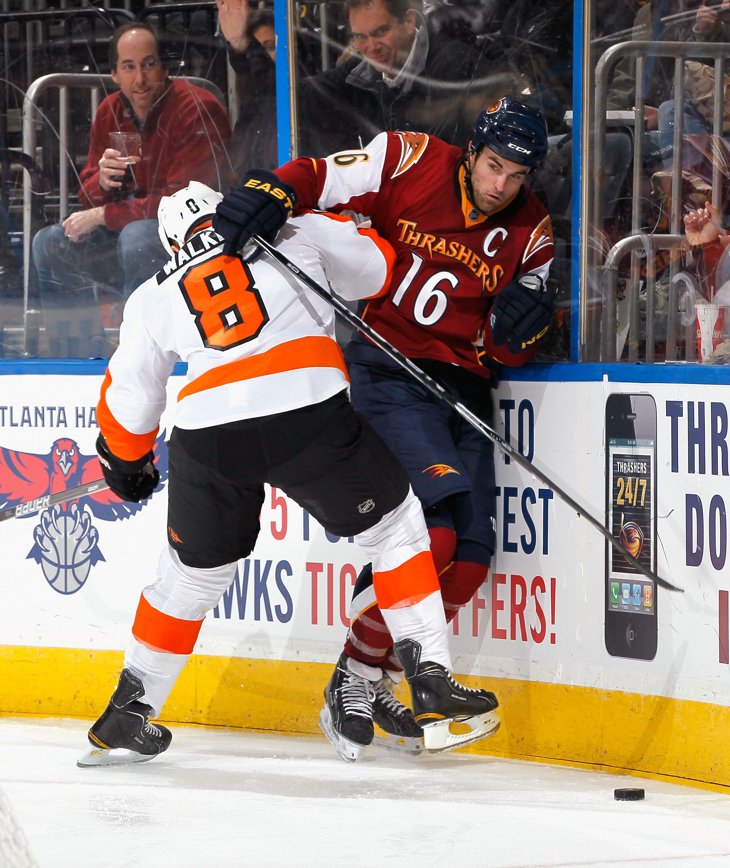 ATLANTA, GA - JANUARY 14:  Andrew Ladd #16 of the Atlanta Thrashers is checked into the boards by Matt Walker #8 of the Philadelphia Flyers at Philips Arena on January 14, 2011 in Atlanta, Georgia.  (Photo by Kevin C. Cox/Getty Images)