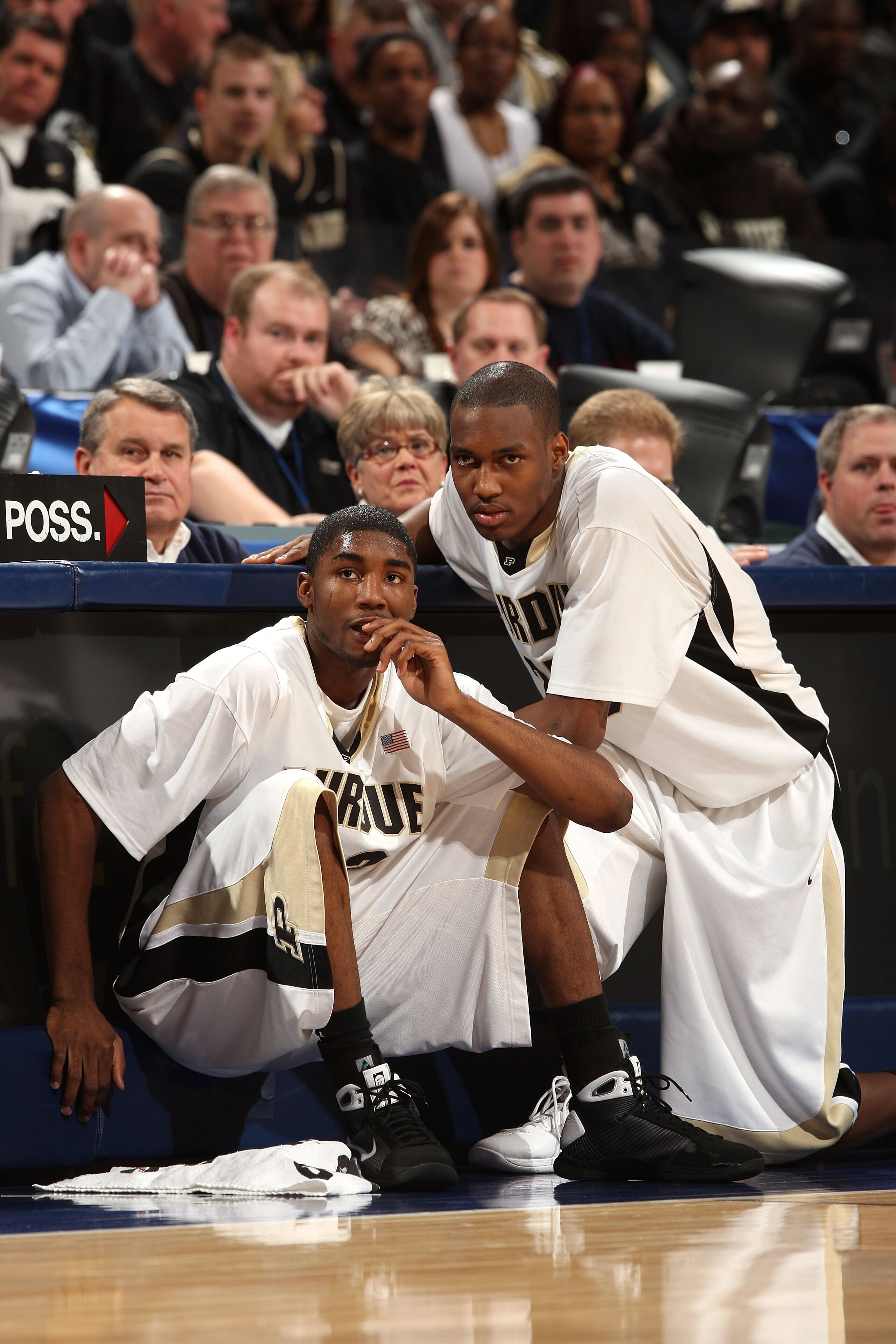 INDIANAPOLIS - MARCH 15:  (L-R) E'Twaun Moore #33 and JaJuan Johnson #25 of the Purdue Boilermakers sit next to the scorer's table as they wait to enter the game against the Ohio State Buckeyes during the final of the Big Ten Men's Basketball Tournament a