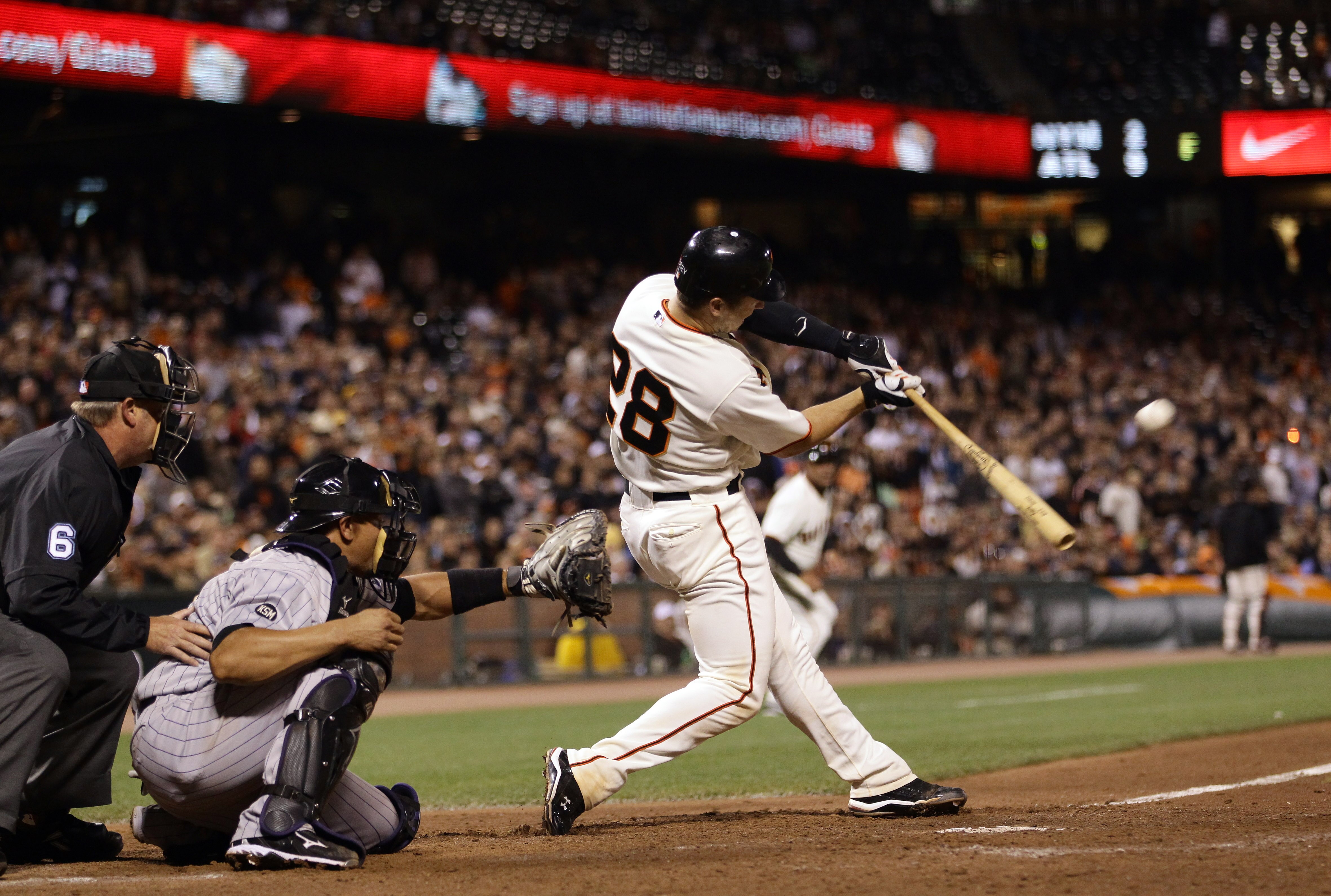 SAN FRANCISCO - AUGUST 31:  Buster Posey #28 of the San Francisco Giants hits a double that scored Freddy Sanchez and Pat Burrell in the eighth inning against the Colorado Rockies at AT&T Park on August 31, 2010 in San Francisco, California.  (Photo by Ez