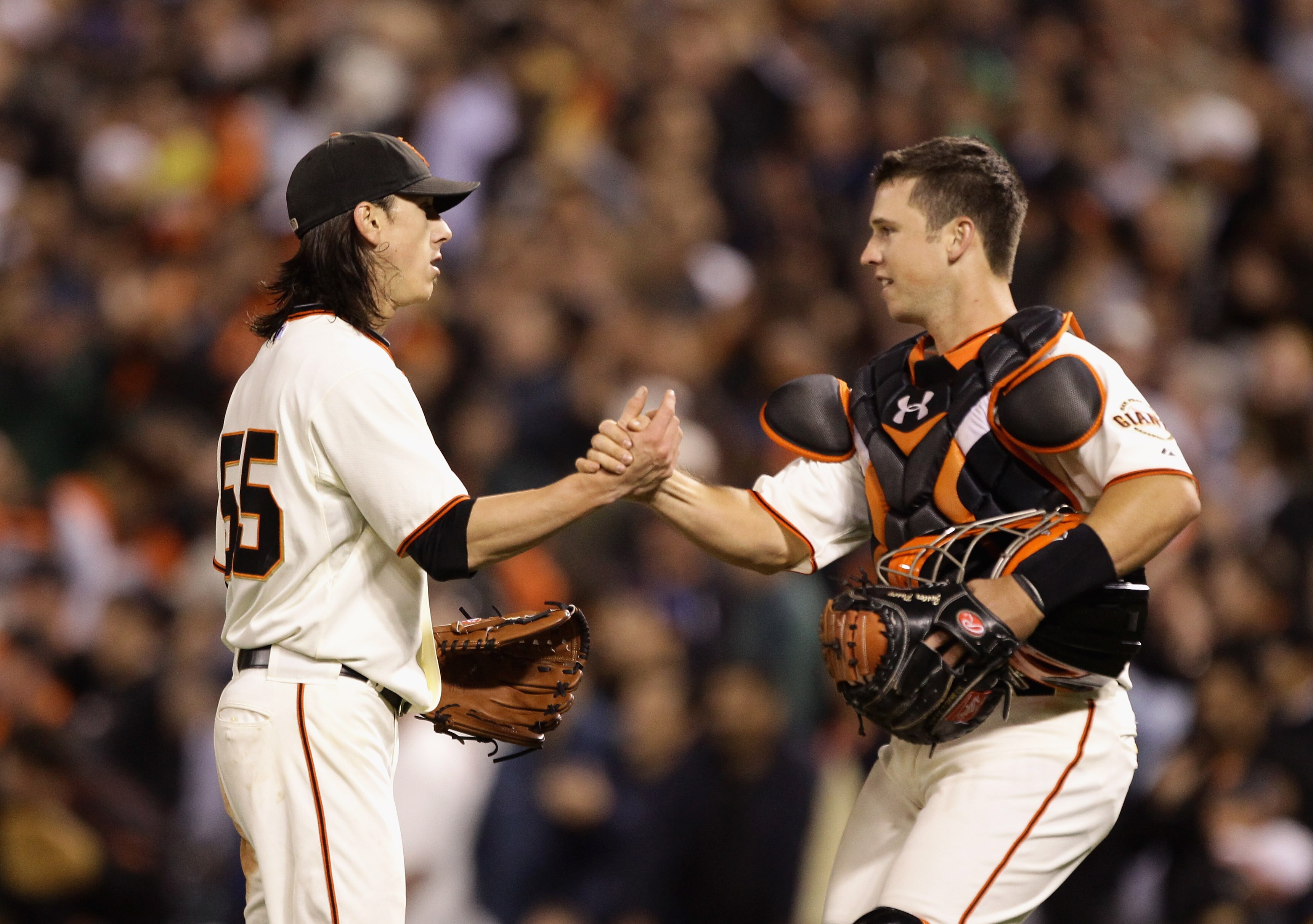 SAN FRANCISCO - JULY 15:  Tim Lincecum #55 of the San Francisco Giants is congratulated by Buster Posey #28 after Lincecum pitched a complete game shut out against the New York Mets at AT&T Park on July 15, 2010 in San Francisco, California.  (Photo by Ez