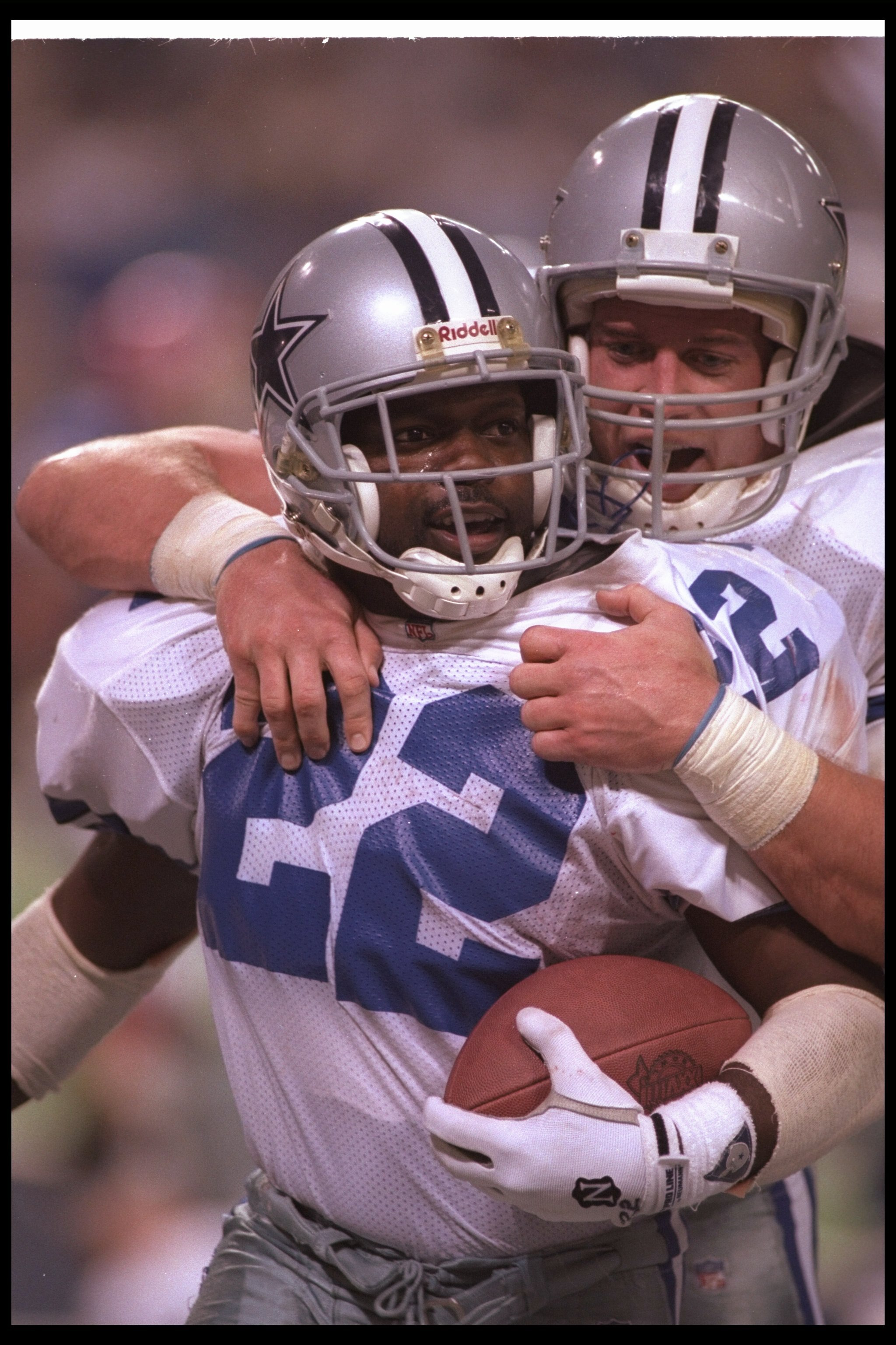 30 Jan 1994: Running back Emmitt Smith of the Dallas Cowboys celebrates with teammate fullback Daryl Johnston during Super Bowl XXVIII against the Buffalo Bills at the Georgia Dome in Atlanta, Georgia. The Cowboys won the game, 30-13.